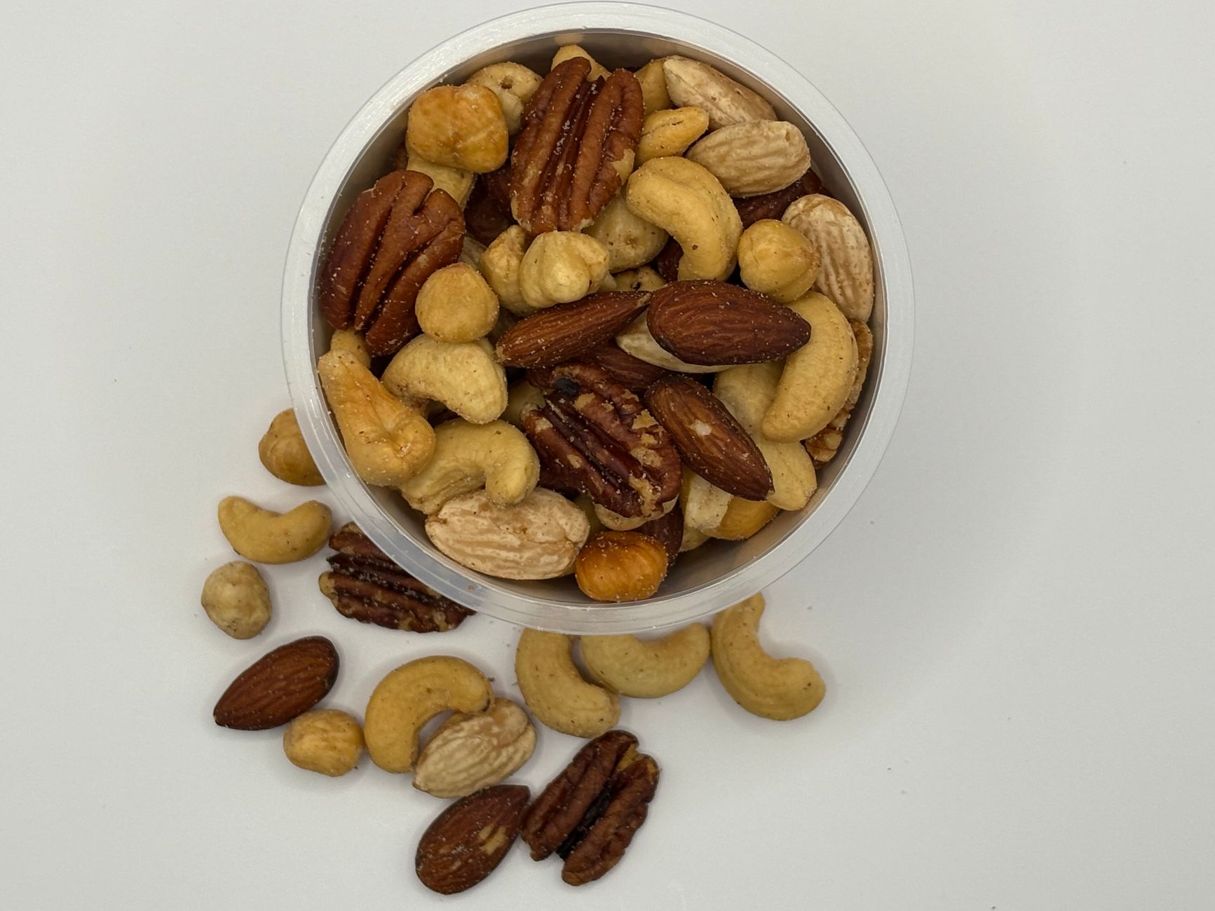 a selection of healthier snack alternatives for pregnancy, including dark chocolate squares, apple slices, and Greek yogurt with honey, arranged on a bright kitchen counter