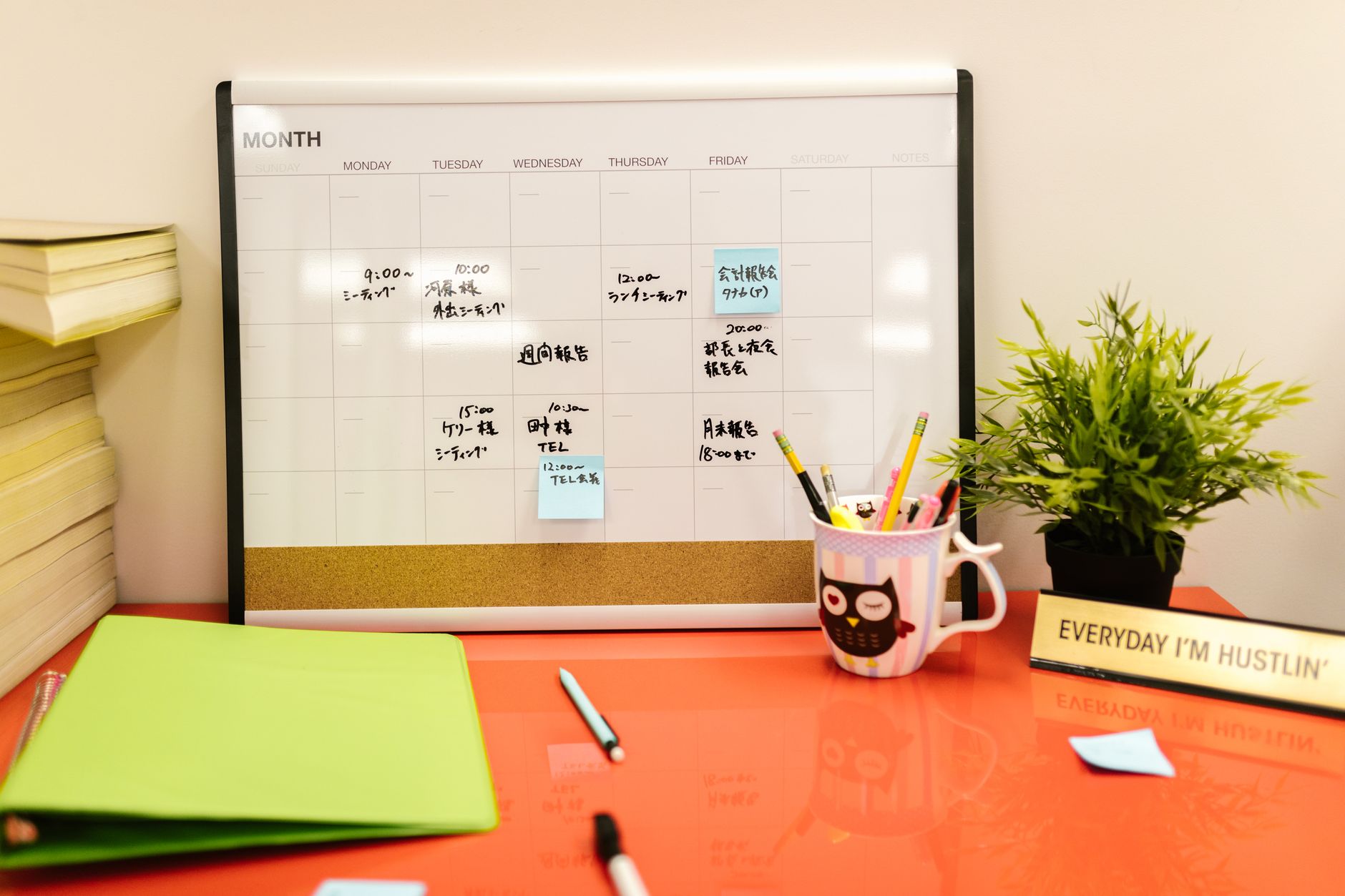 a close‑up of a planner, a water bottle, and a set of colored pens on a desk, symbolizing organized daily routines for managing ADHD during pregnancy