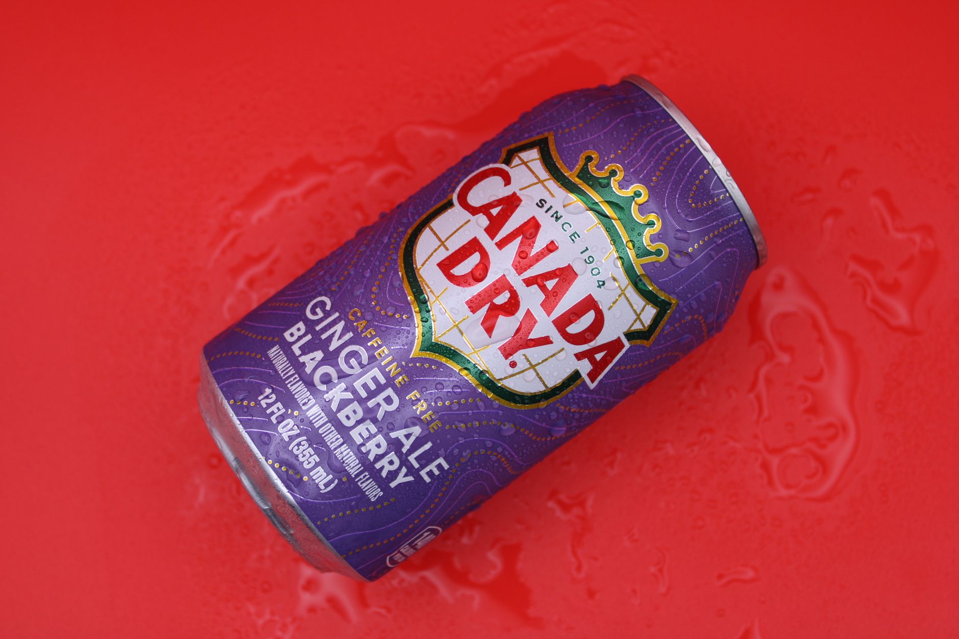 A variety of colorful sparkling water cans from different brands, including Aha, LaCroix, and Bubly, arranged on a light background.