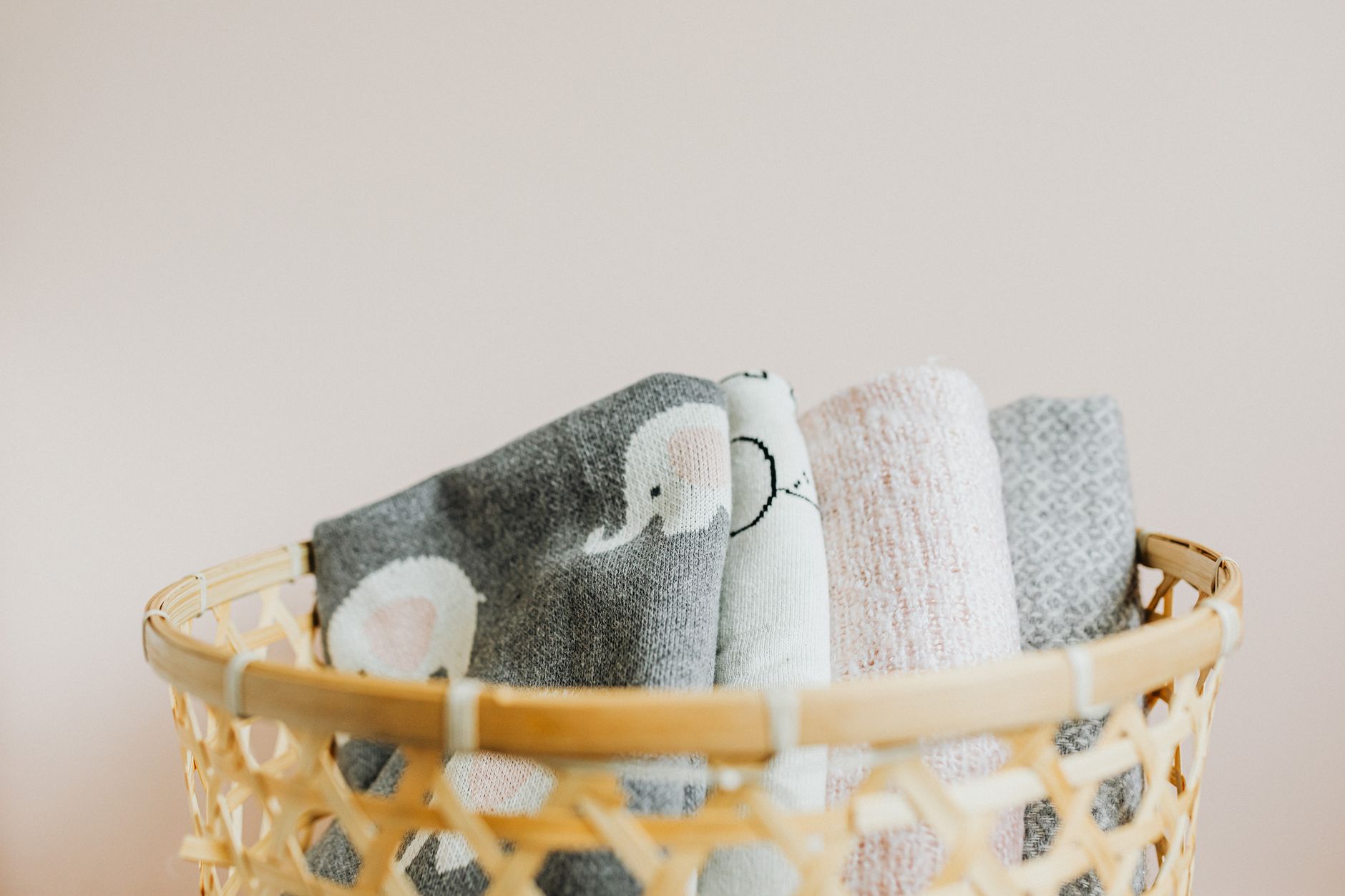 a hand holding a clean, cool washcloth ready for a baby to chew, soft natural light