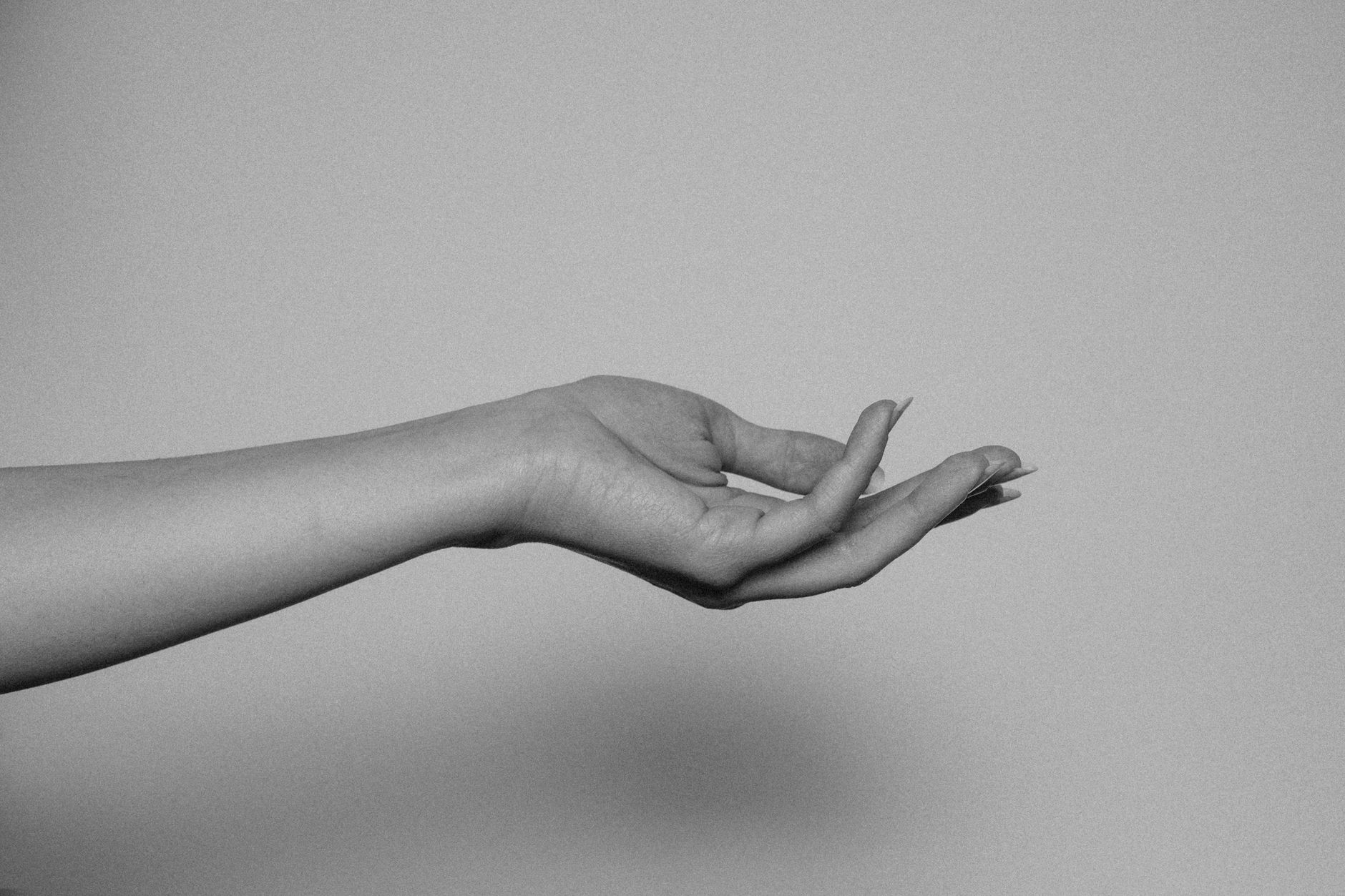 A gentle hand applying a pea‑sized amount of arnica gel to a forearm, illustrating proper topical use during pregnancy