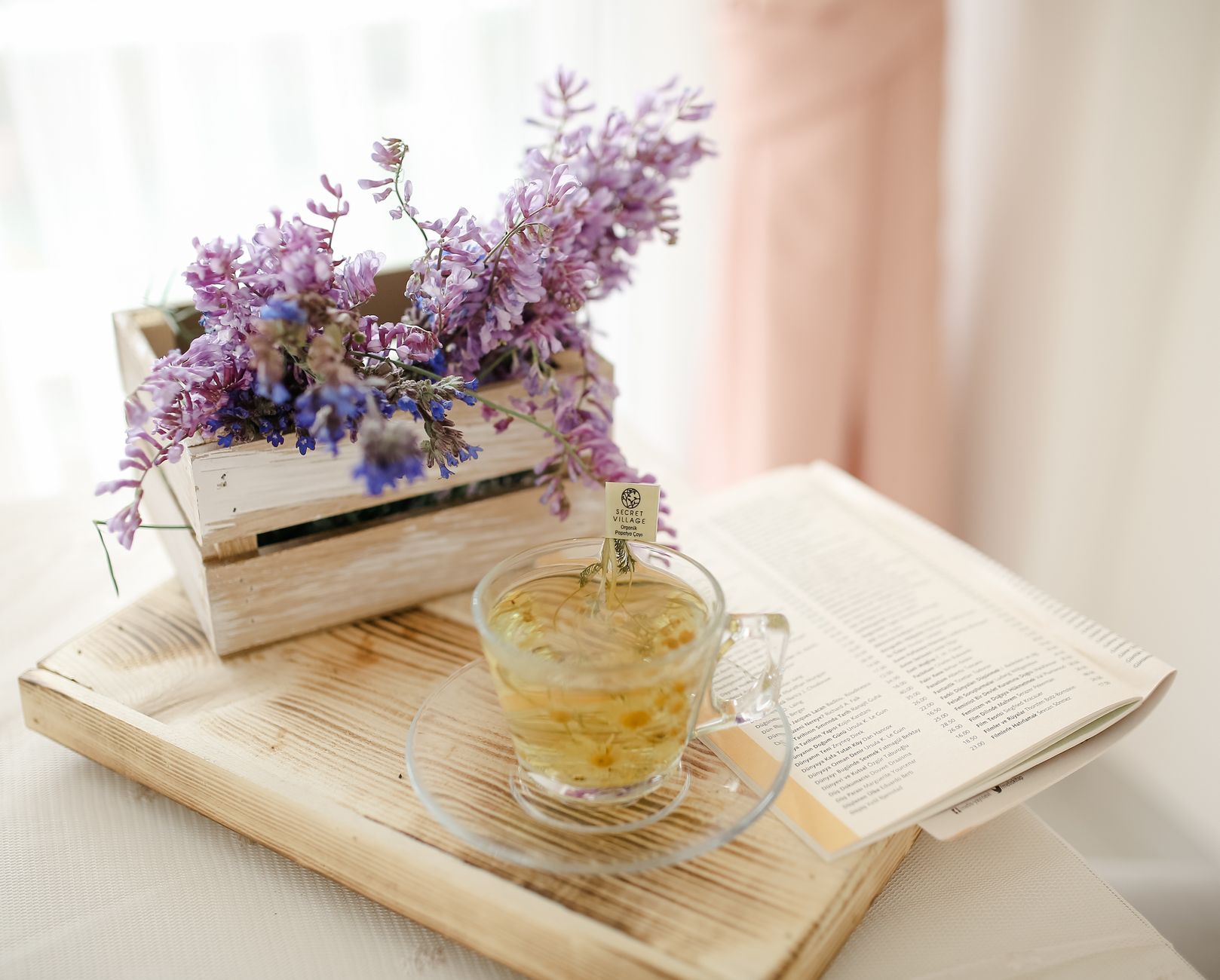 A calming lavender essential oil bottle next to a cup of chamomile tea, illustrating natural pain‑relief alternatives for pregnant individuals
