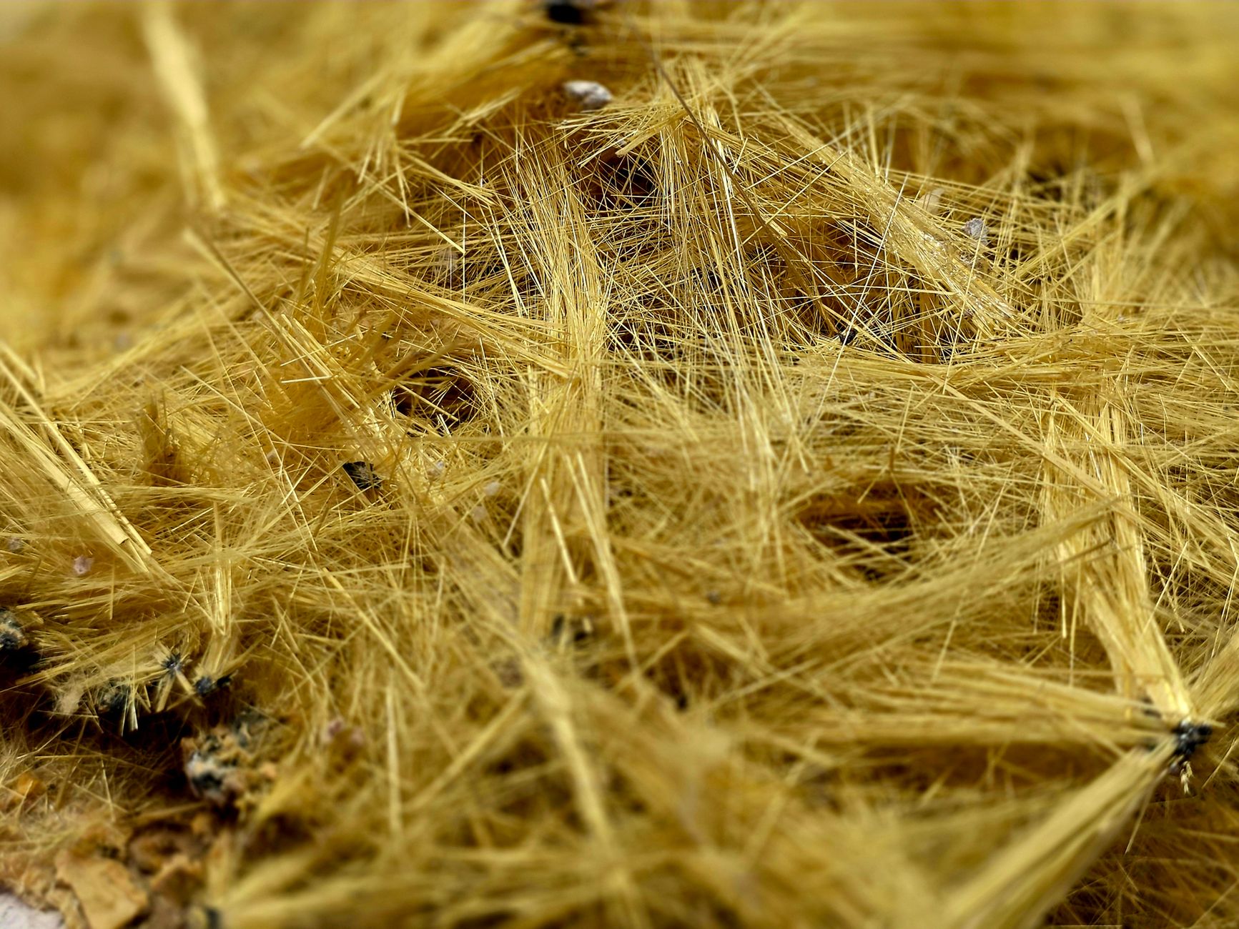 A side-by-side comparison of asbestos-containing insulation (left) and modern asbestos-free insulation materials (right), with labels indicating safe alternatives like cellulose or foam