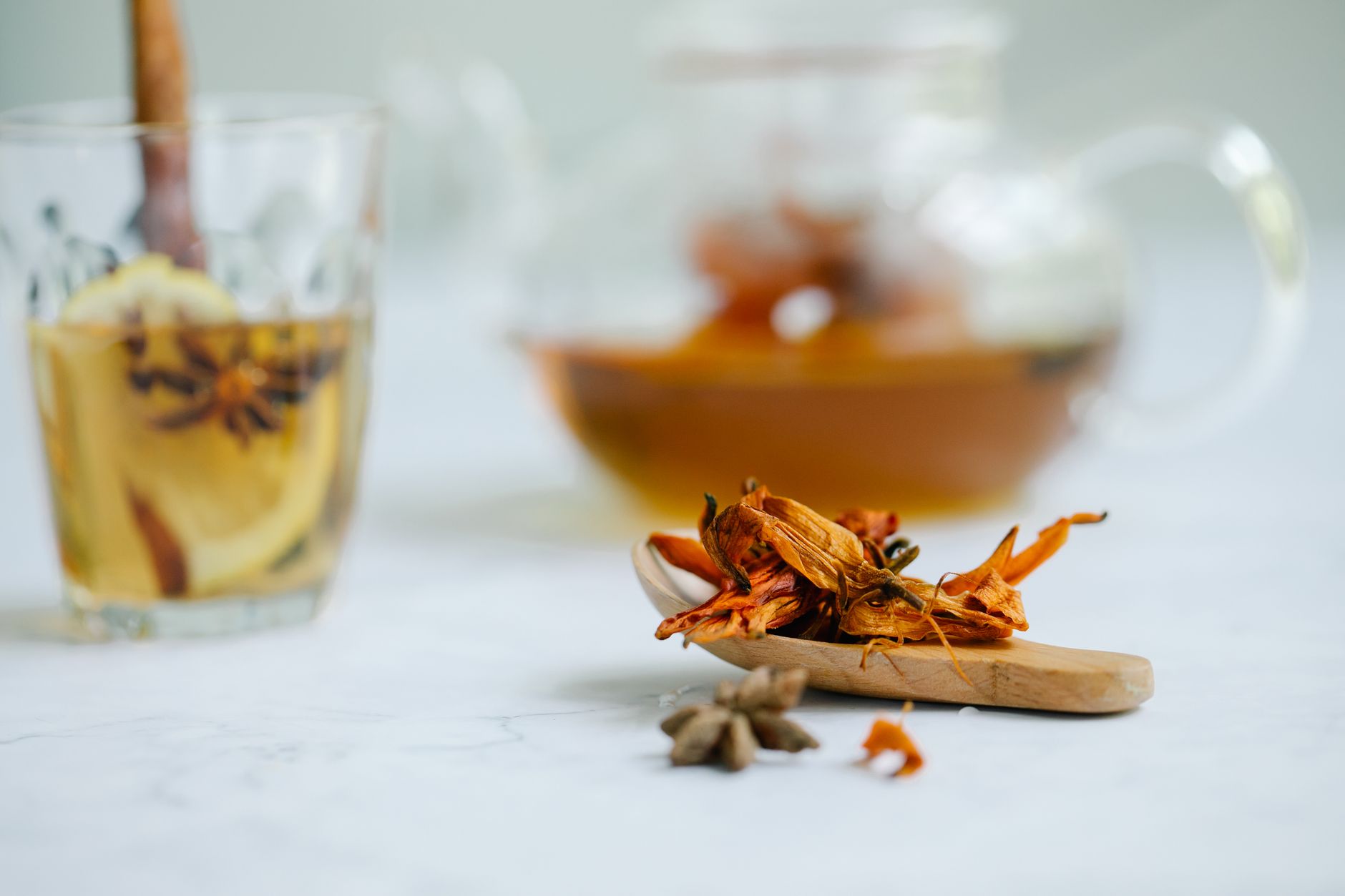 A calming tea set with chamomile flowers, a mug of ginger tea, and a small bowl of fresh berries on a pastel tablecloth, illustrating pregnancy‑safe herbal options
