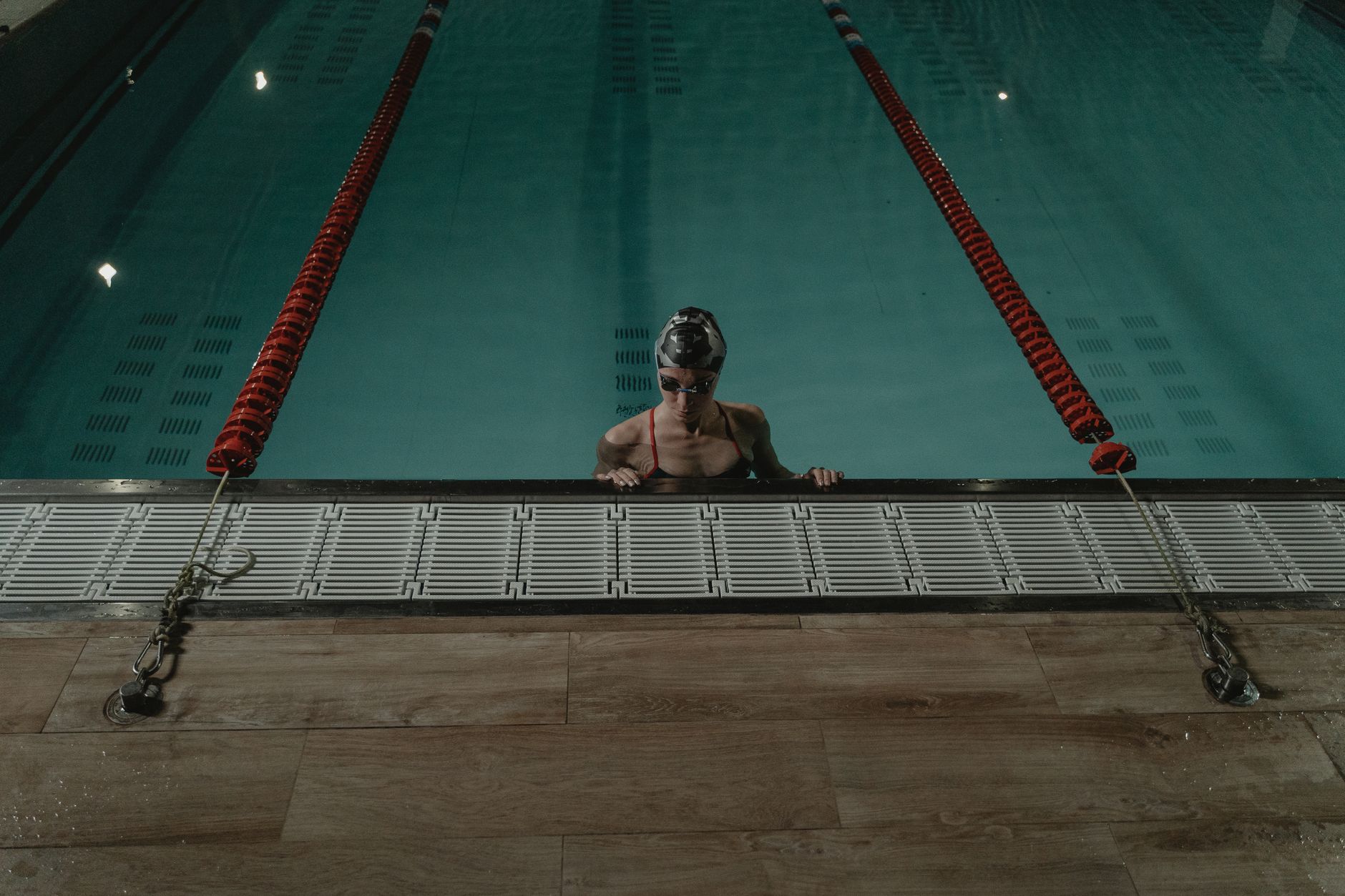A bright indoor pool with a pregnant woman gently moving through water aerobics, showcasing a low‑impact exercise alternative for prenatal fitness