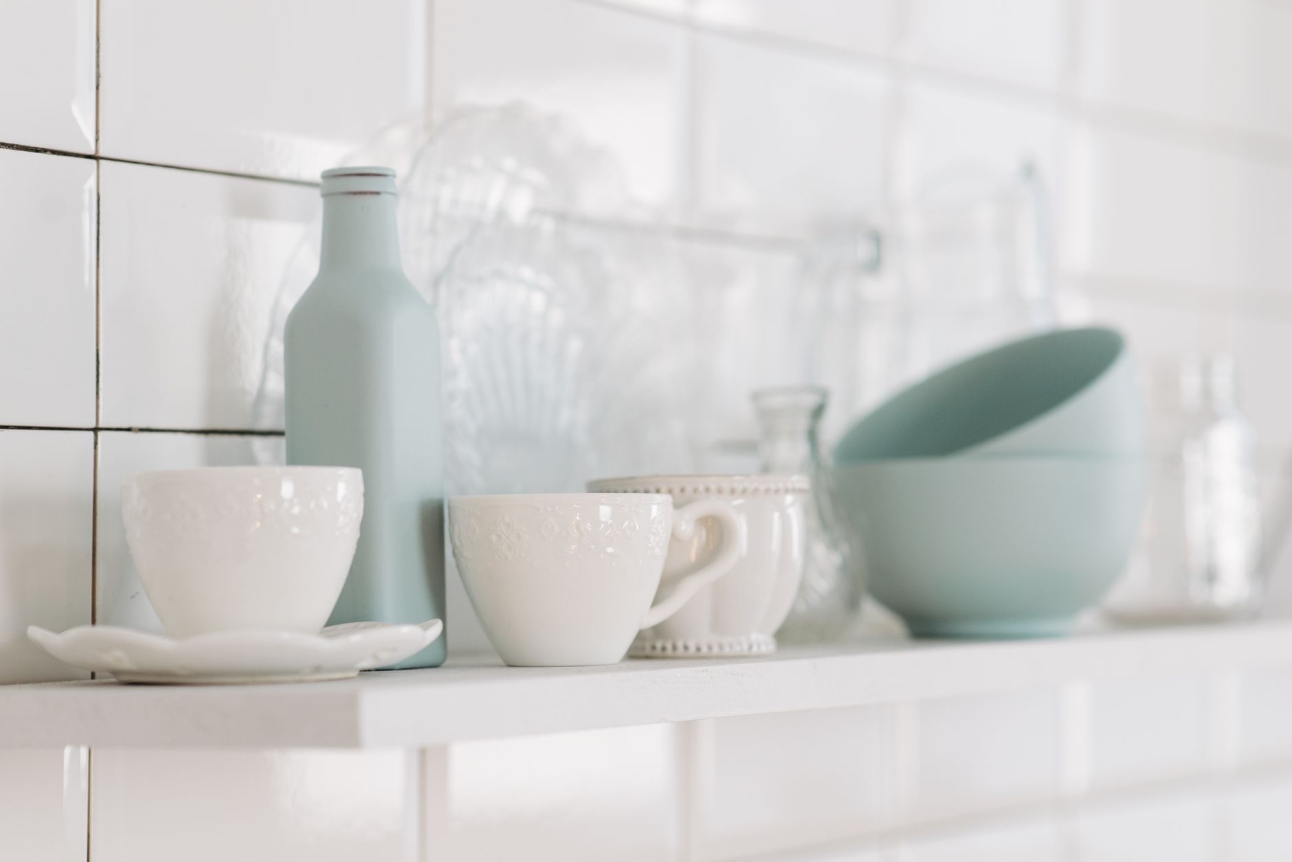assorted pregnancy‑safe beverage options including plain water, unsweetened almond milk, ginger tea, and a bottle of electrolyte drink, arranged on a pastel kitchen shelf