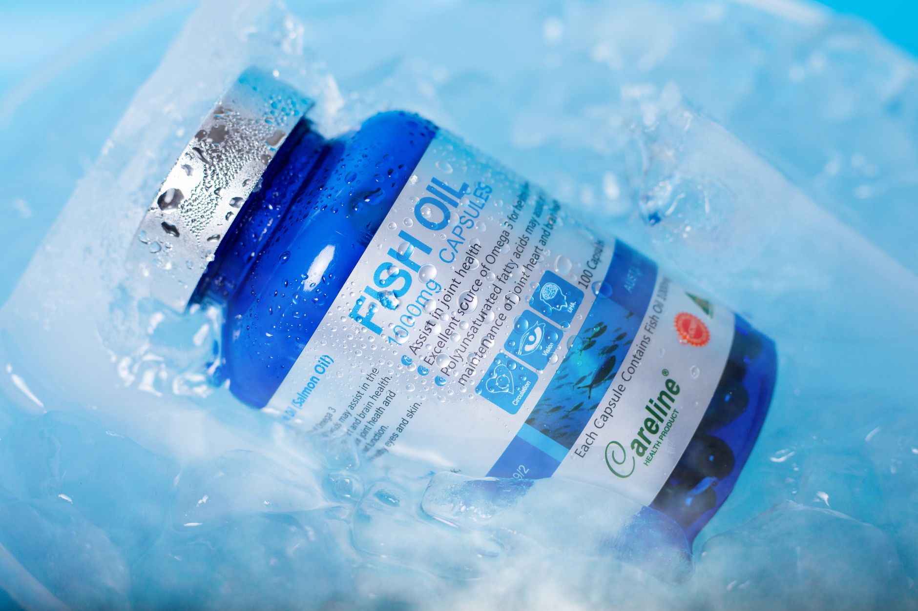 Close‑up of a colostrum supplement capsule next to a prenatal vitamin bottle, highlighting the contrast between animal‑derived and vitamin supplements