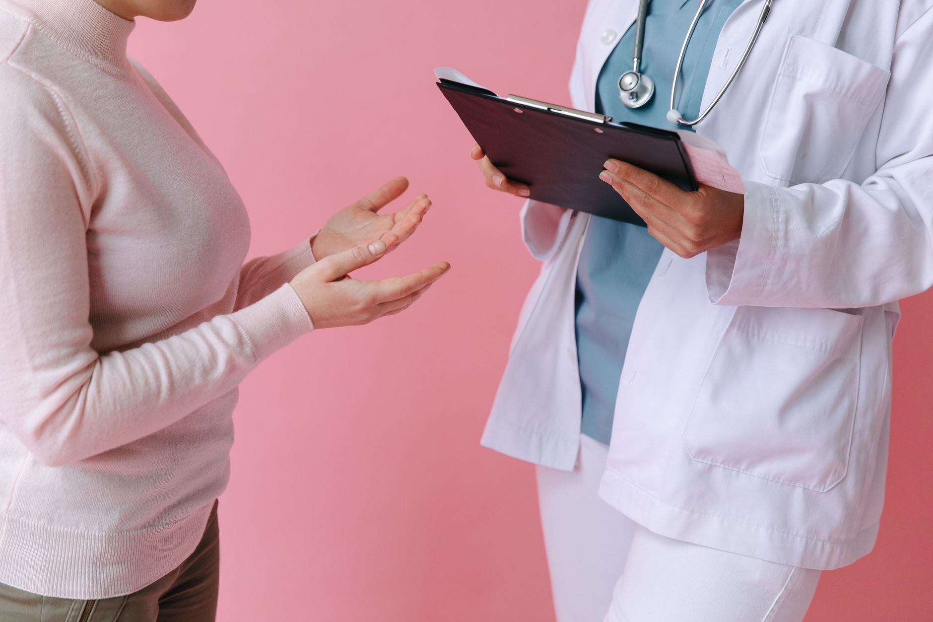 pregnant woman discussing medication options with her doctor in a clinic