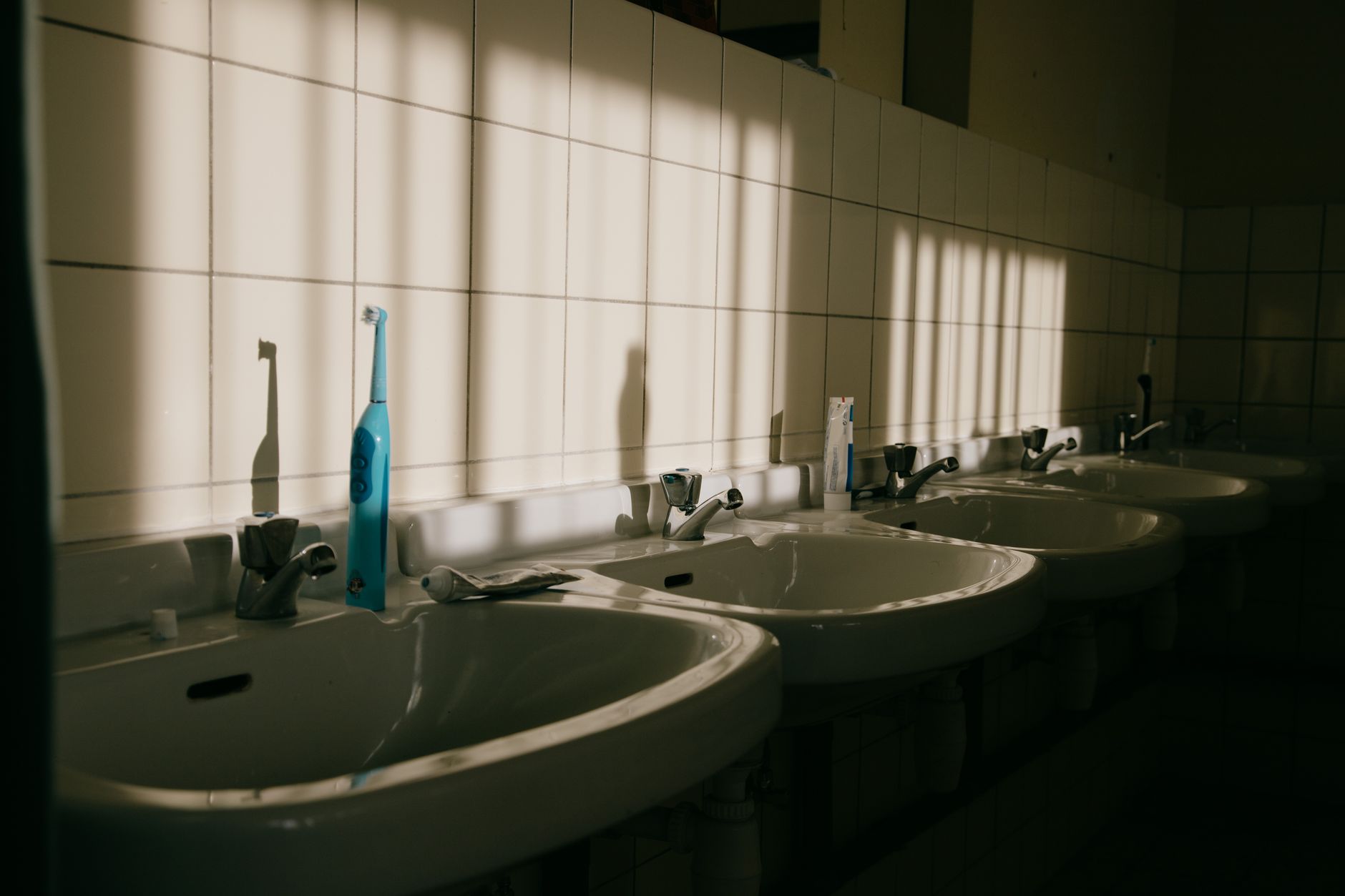 assortment of over‑the‑counter topical antifungal creams on a bathroom sink, soft natural light highlighting product labels
