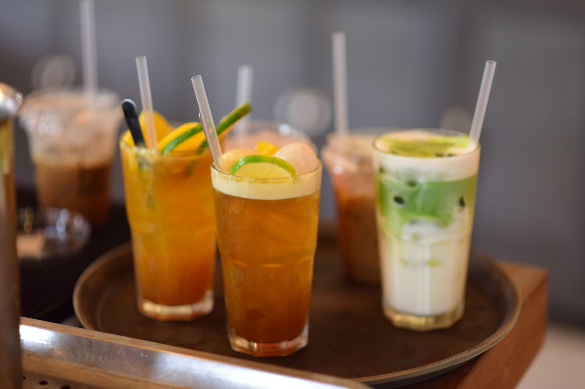 a selection of pregnancy‑friendly beverages on a kitchen counter, including a small Dunkin Coolatta, a decaf iced coffee, a fruit smoothie, and a glass of coconut water, illustrating safe alternatives