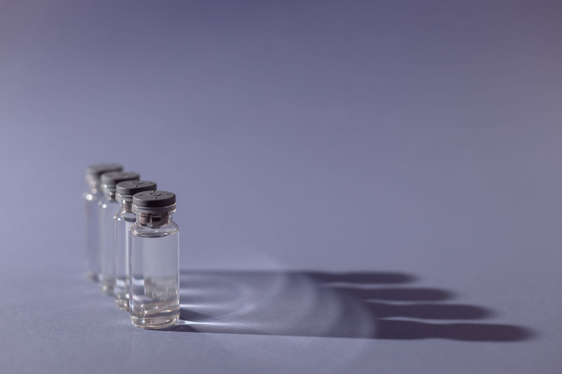 close‑up of a flu vaccine vial labeled with a pregnancy‑safe icon, placed next to a prenatal vitamin bottle on a kitchen counter, soft natural lighting highlighting the product