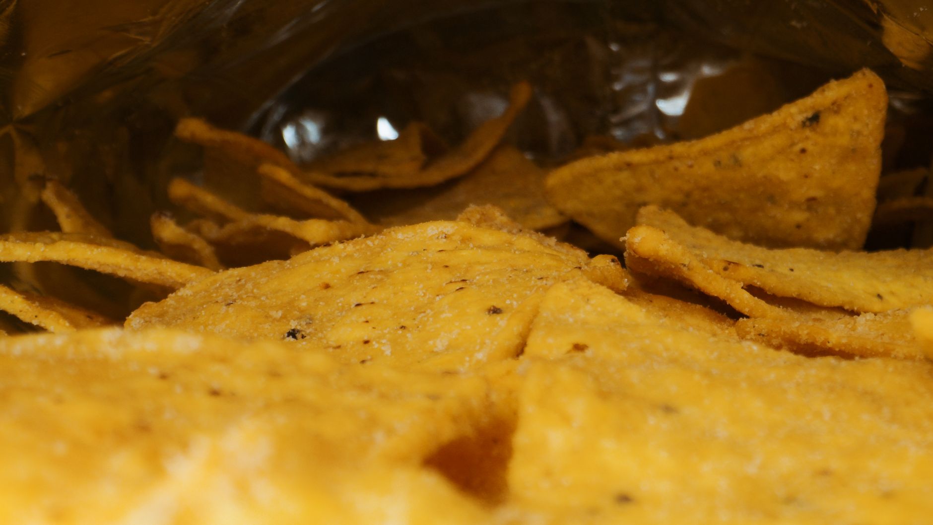 low‑sodium Fritos bag next to a measuring cup showing one ounce of chips, bright kitchen setting, emphasizing portion control