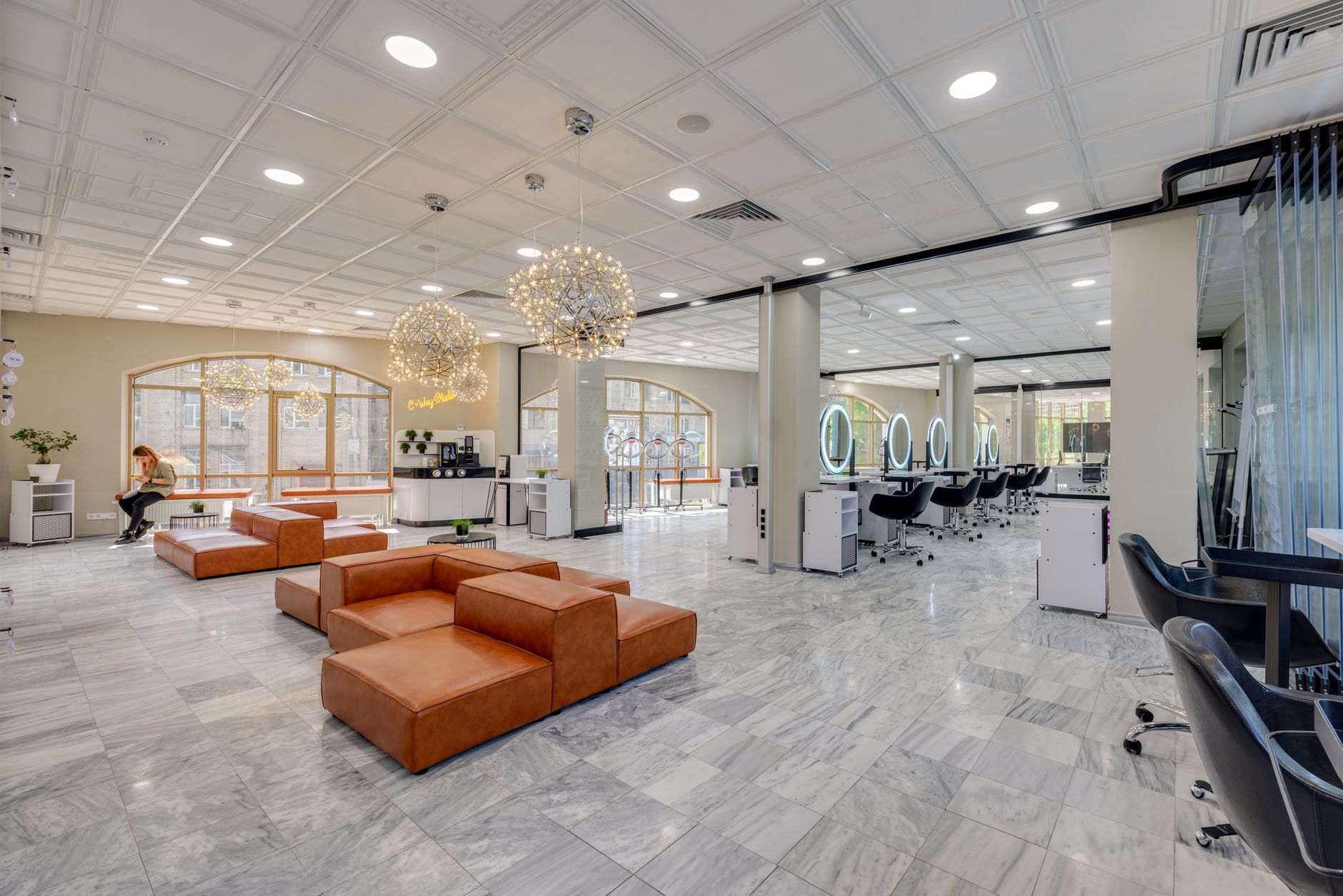 a modern salon with an open window, a professional applying hair color while a pregnant client watches, emphasizing good ventilation and gentle handling
