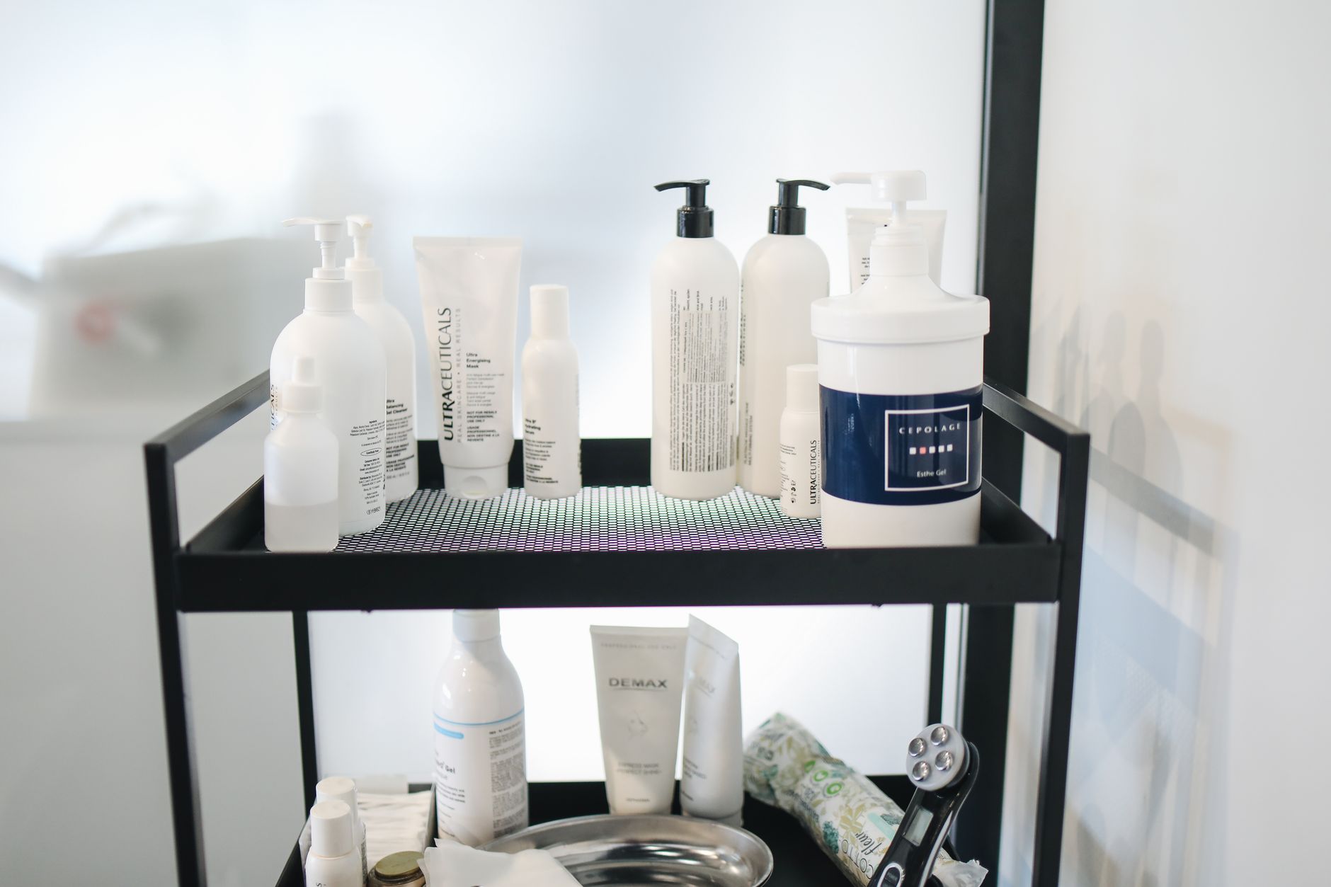 Various bottles of Olaplex products (No 4, 5, 6, 7, 8) neatly arranged on a white shelf with soft lighting
