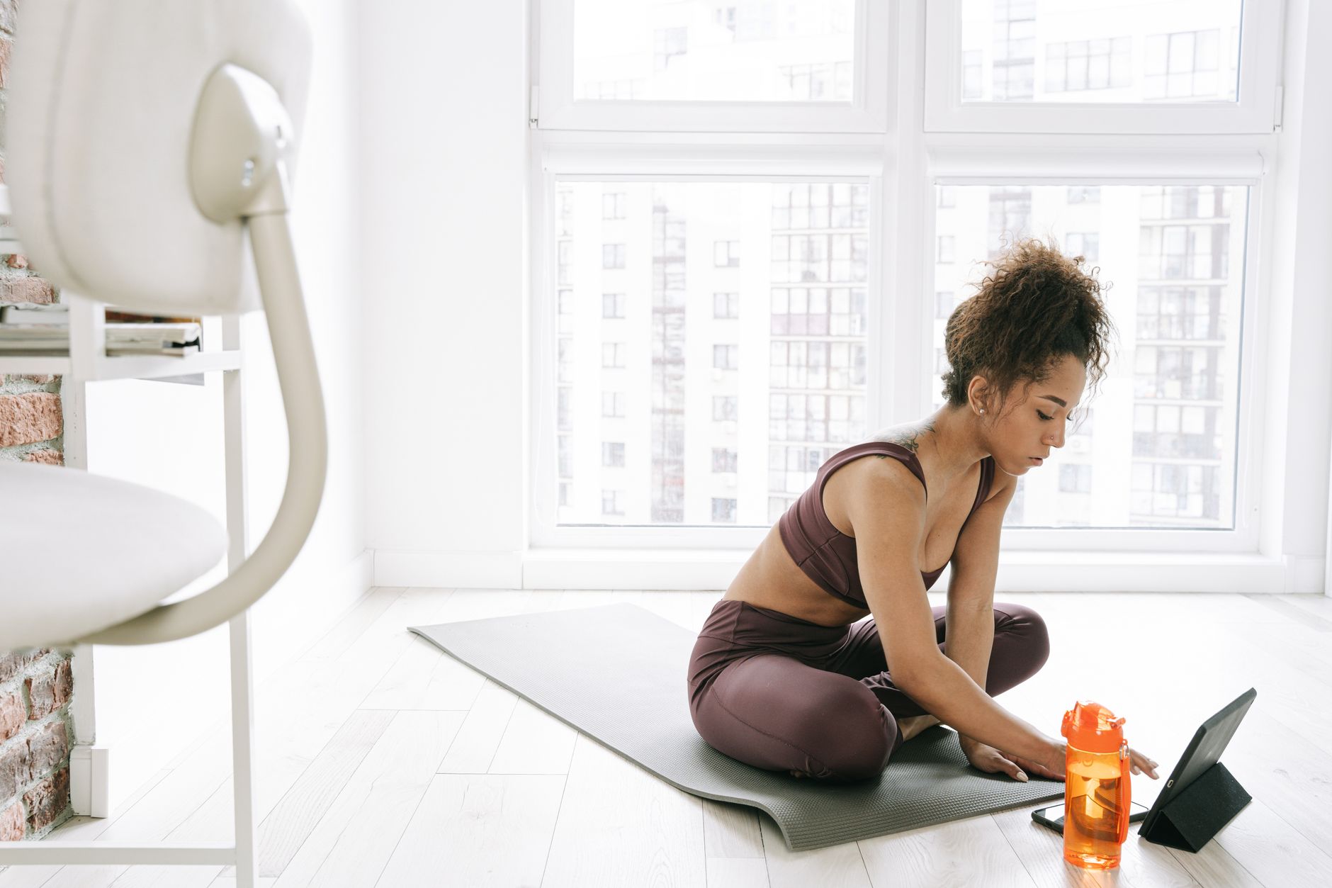 a serene studio corner with a yoga mat, a water bottle, and a pregnancy‑safe dance playlist displayed on a tablet, soft natural light highlighting the calm space