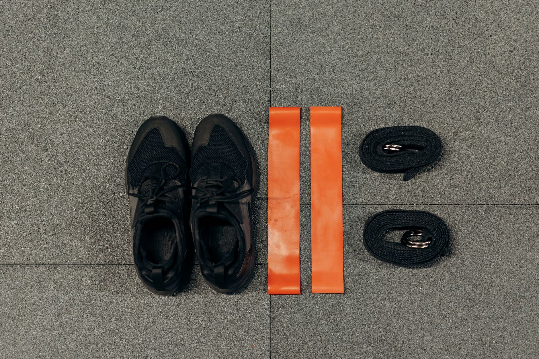 Close-up of a water bottle, towel, and pregnancy-safe exercise gear on a yoga mat