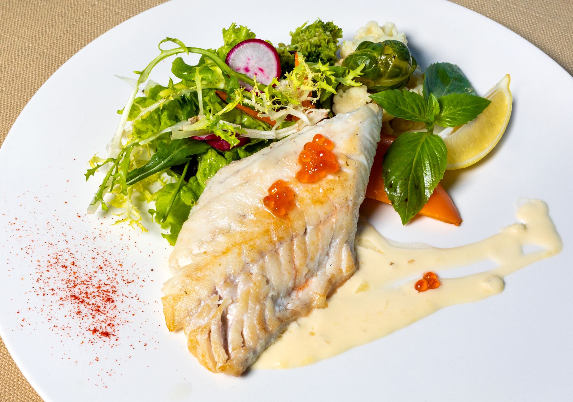 a selection of fully cooked fish fillets on a plate, showing safe options for pregnant women seeking omega‑3s