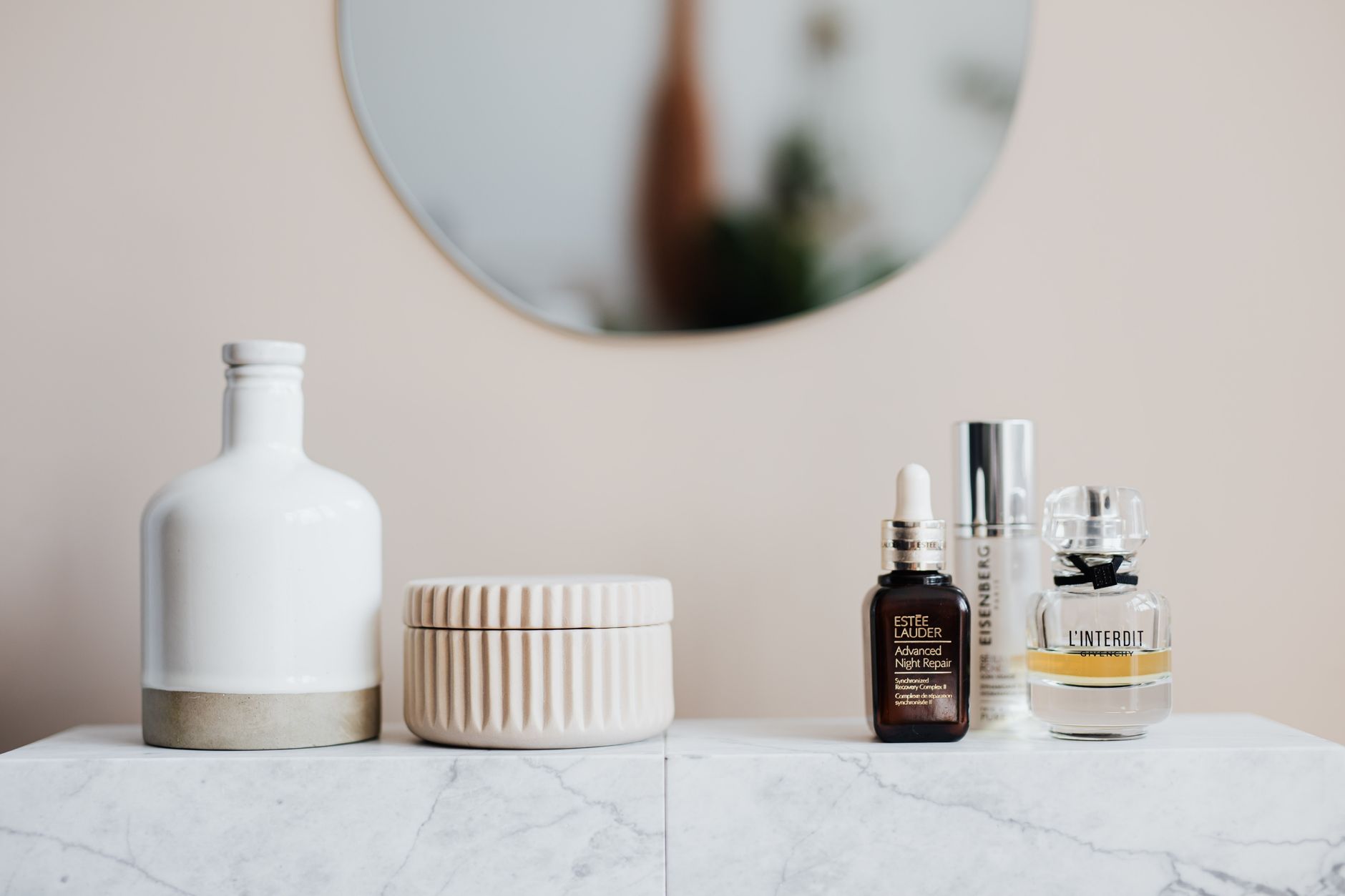 A calming bathroom shelf displaying a hyaluronic acid serum bottle beside a cup of herbal tea, soft natural light, emphasizing a gentle pregnancy routine