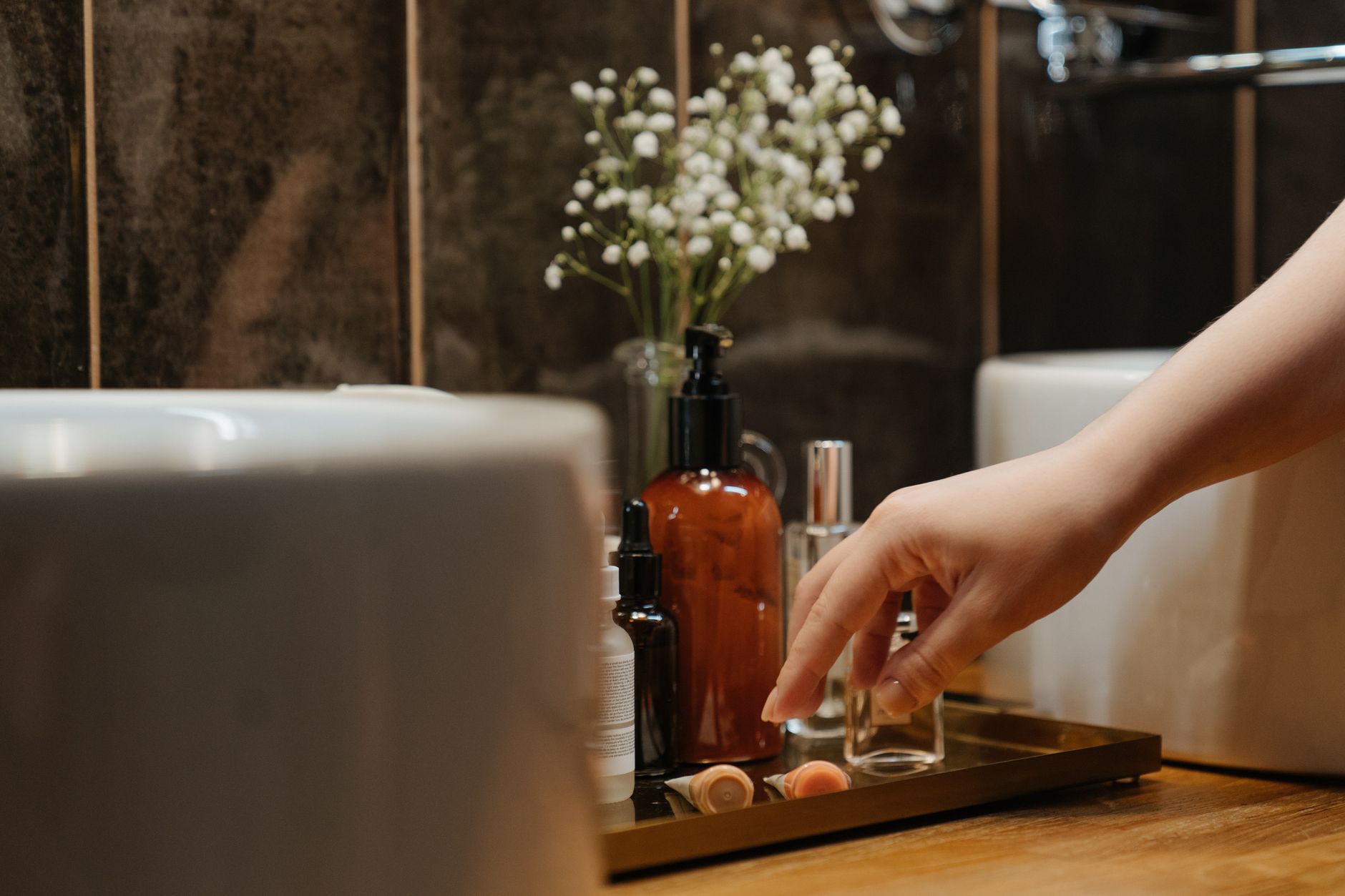 woman gently cleaning a minor cut on her hand with saline solution from a small bottle