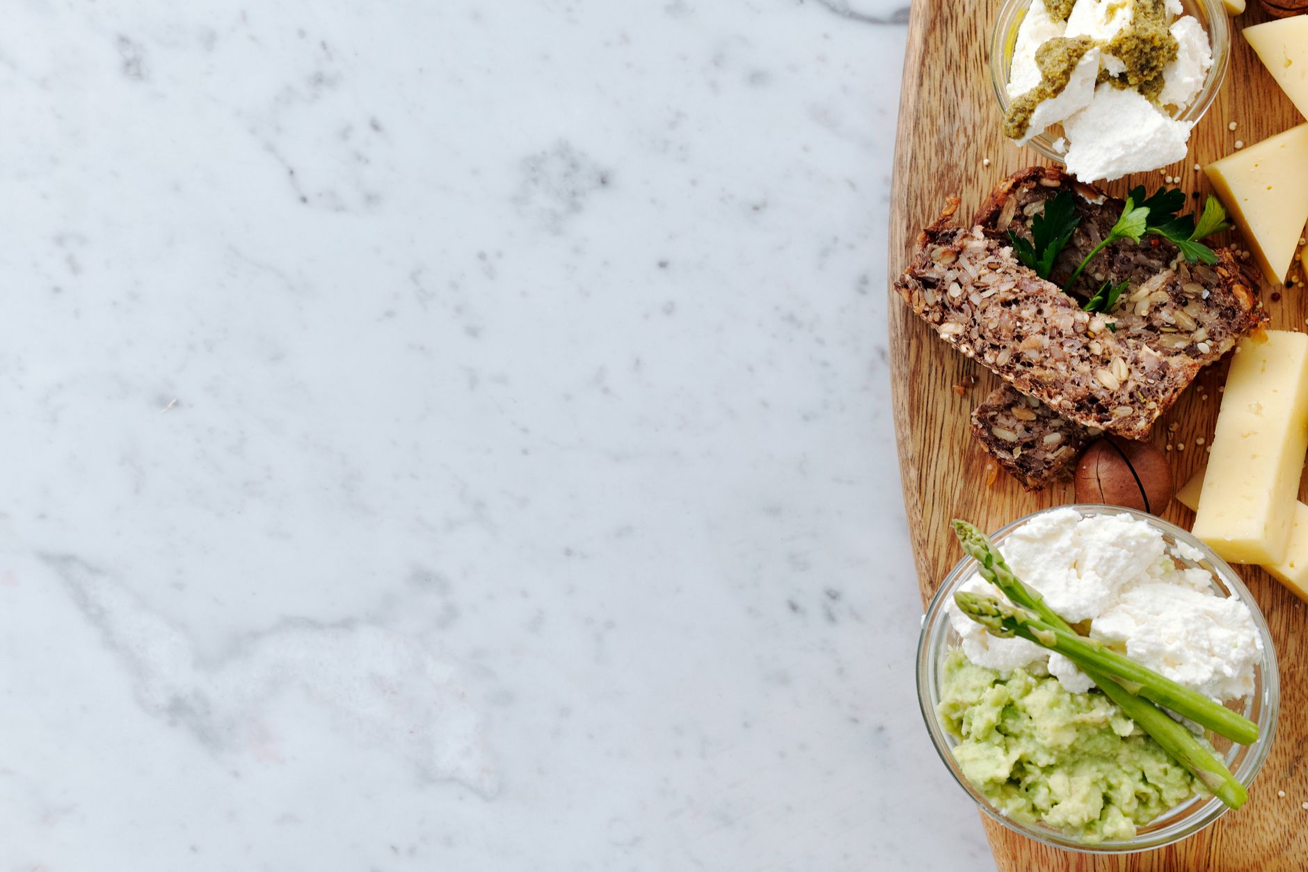 A split image: on the left, a keto meal prep container with fatty cuts of meat, cheese, and avocado; on the right, a pregnancy-safe plate with lean proteins, whole grains, colorful vegetables, and a glass of fortified milk