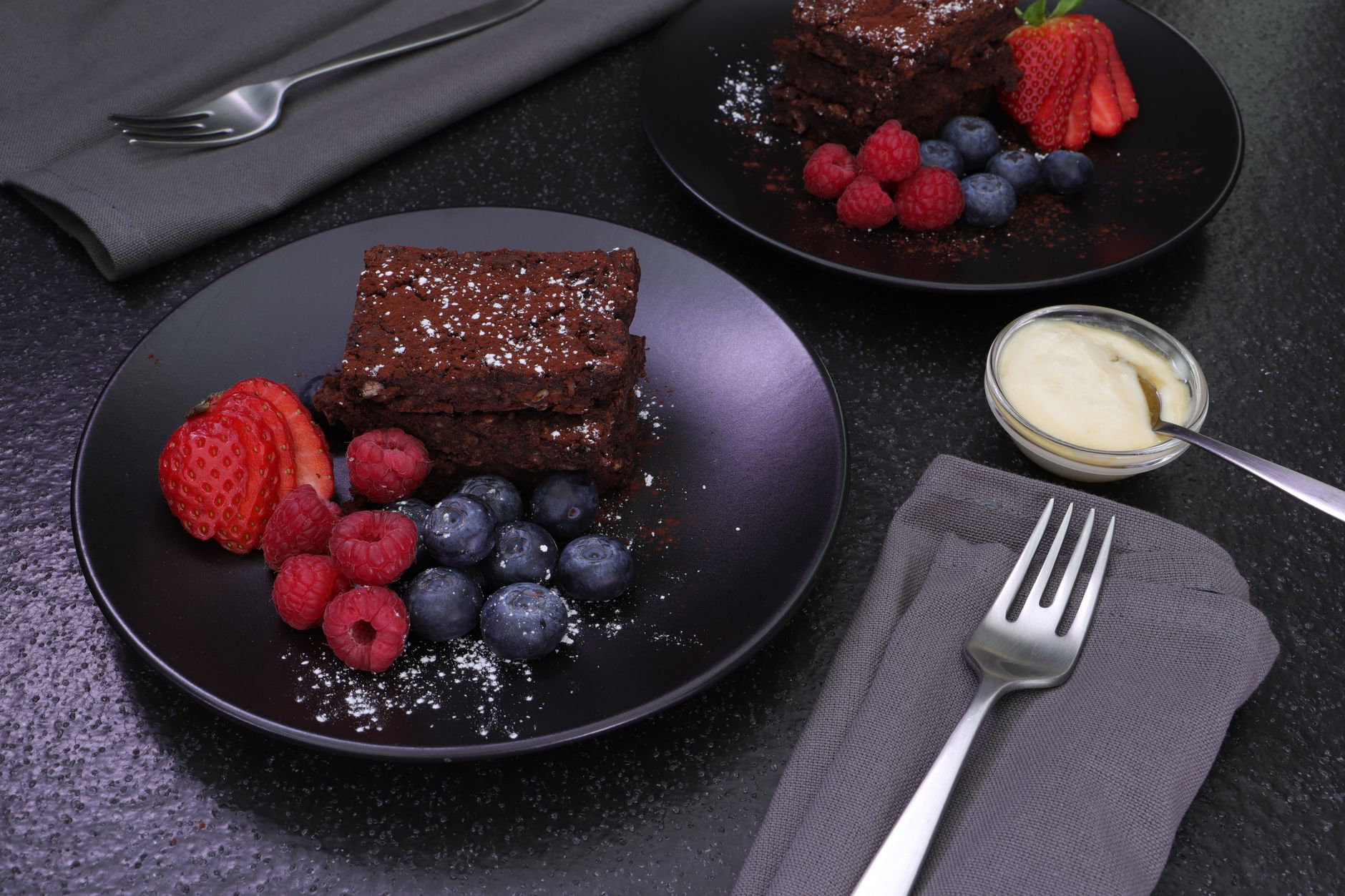 a soothing snack plate featuring Greek yogurt, fresh berries, and a small dark chocolate square, arranged on a pastel-colored plate for a pregnant woman