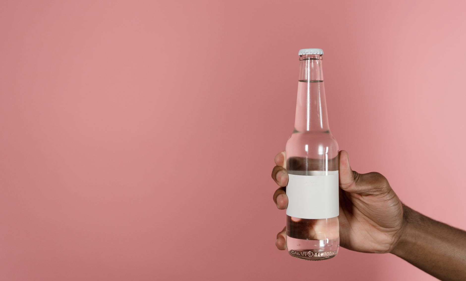 Close‑up of a hand holding a skincare bottle with a clear label showing ingredient list, soft natural light highlighting the text