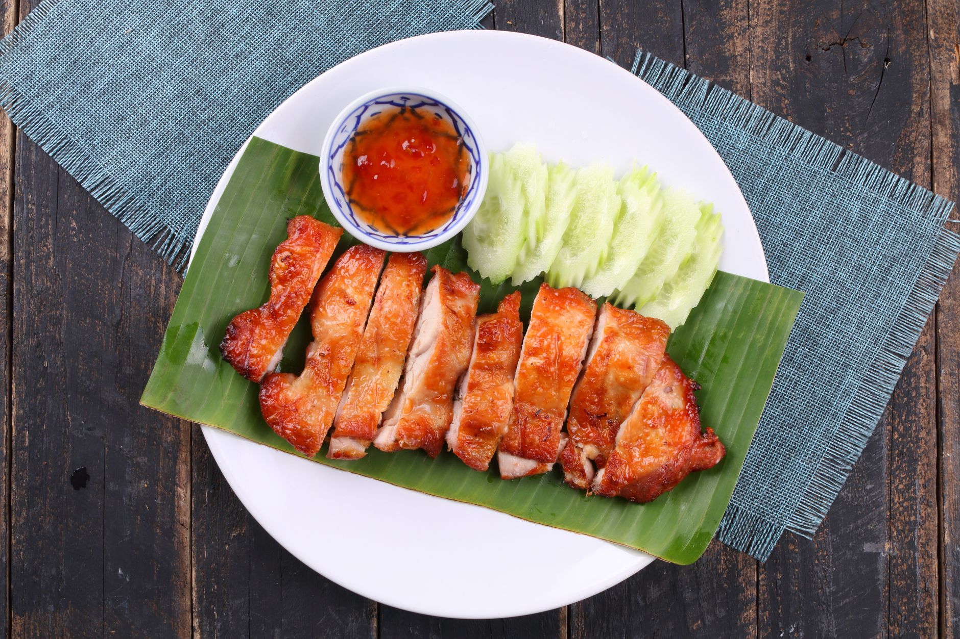 A plate of grilled chicken breast, sliced cucumber, and a small bowl of low‑sodium Korean BBQ sauce, arranged on a pastel plate with soft lighting