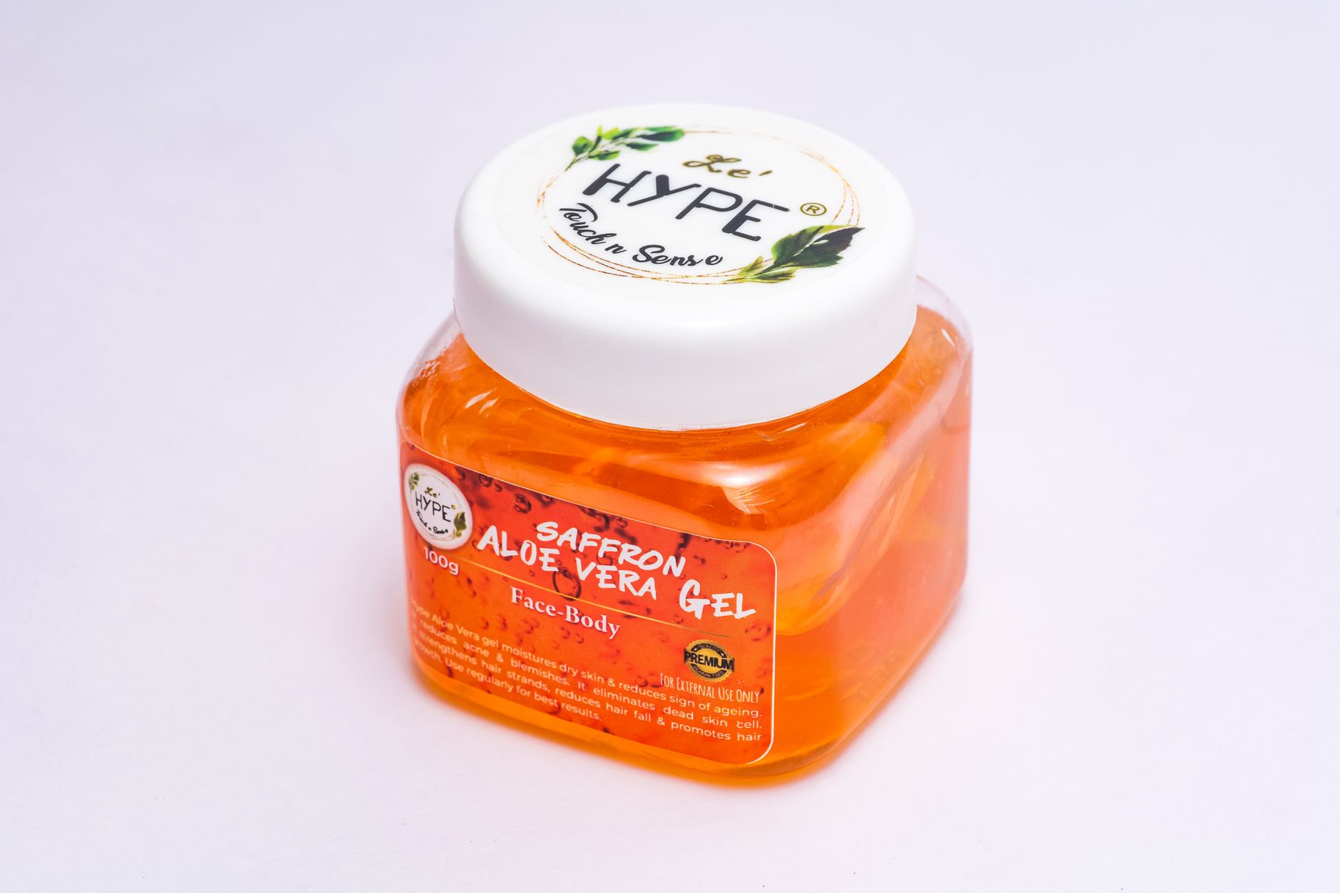 open jar of aloe vera gel with a wooden spoon on a bathroom shelf next to other pregnancy-safe skincare