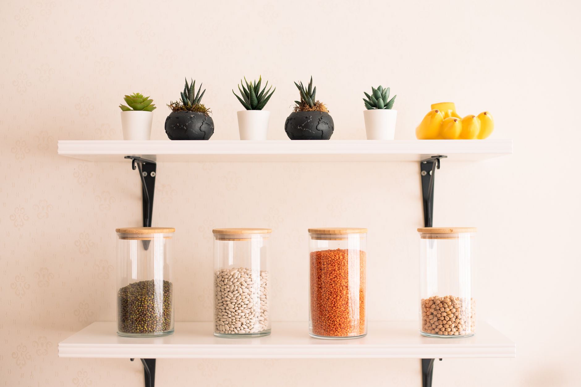 A tidy pantry shelf holding a row of lion's mane supplement bottles, each labeled with clear dosage information, alongside a glass jar of blueberries for a pregnancy‑friendly snack