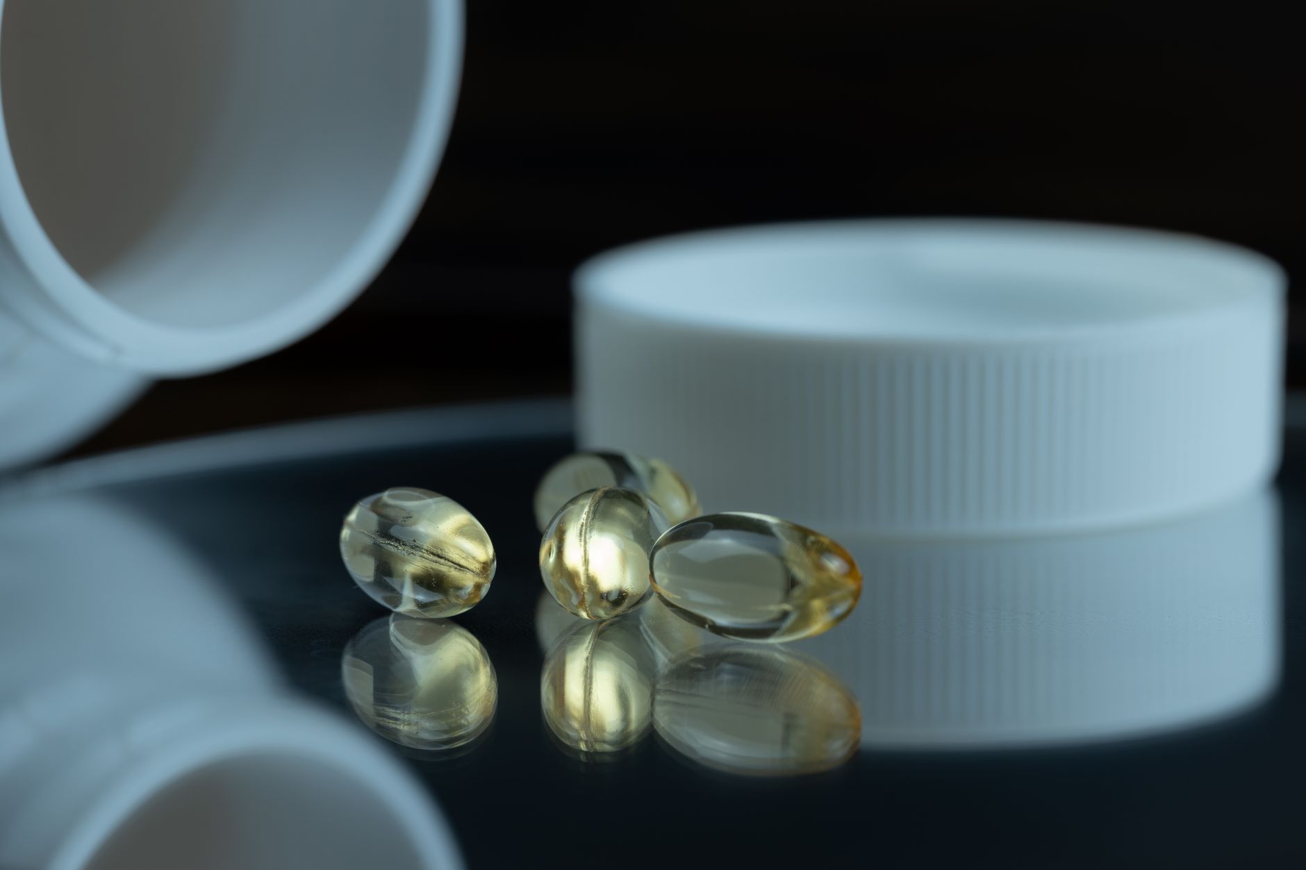 close‑up of a labeled supplement bottle showing a single‑serve maca capsule beside a glass of water on a pastel‑colored nightstand, soft ambient lighting