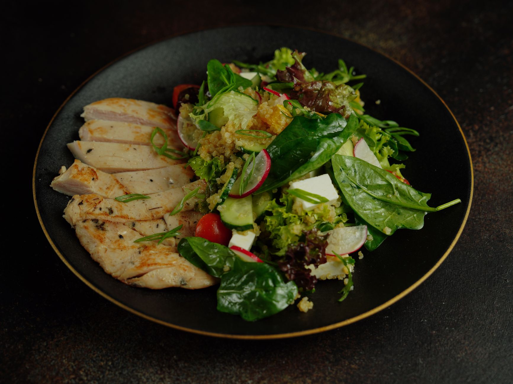 A colorful plate of grilled chicken breast, baked salmon, and quinoa salad, representing safe protein choices for pregnancy