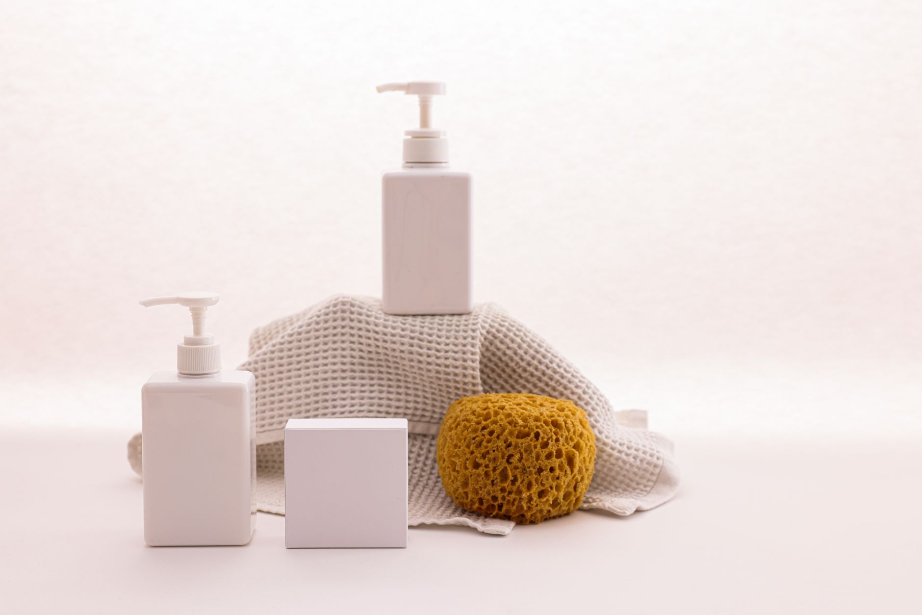 A selection of unscented, hypoallergenic cleaning products on a minimalist shelf, soft lighting