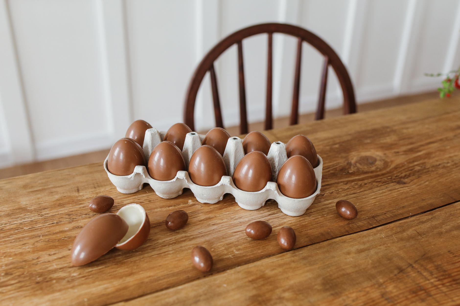 a close‑up of a labeled chocolate mousse container showing 'pasteurized eggs' on the ingredient list, placed on a kitchen counter beside a measuring cup
