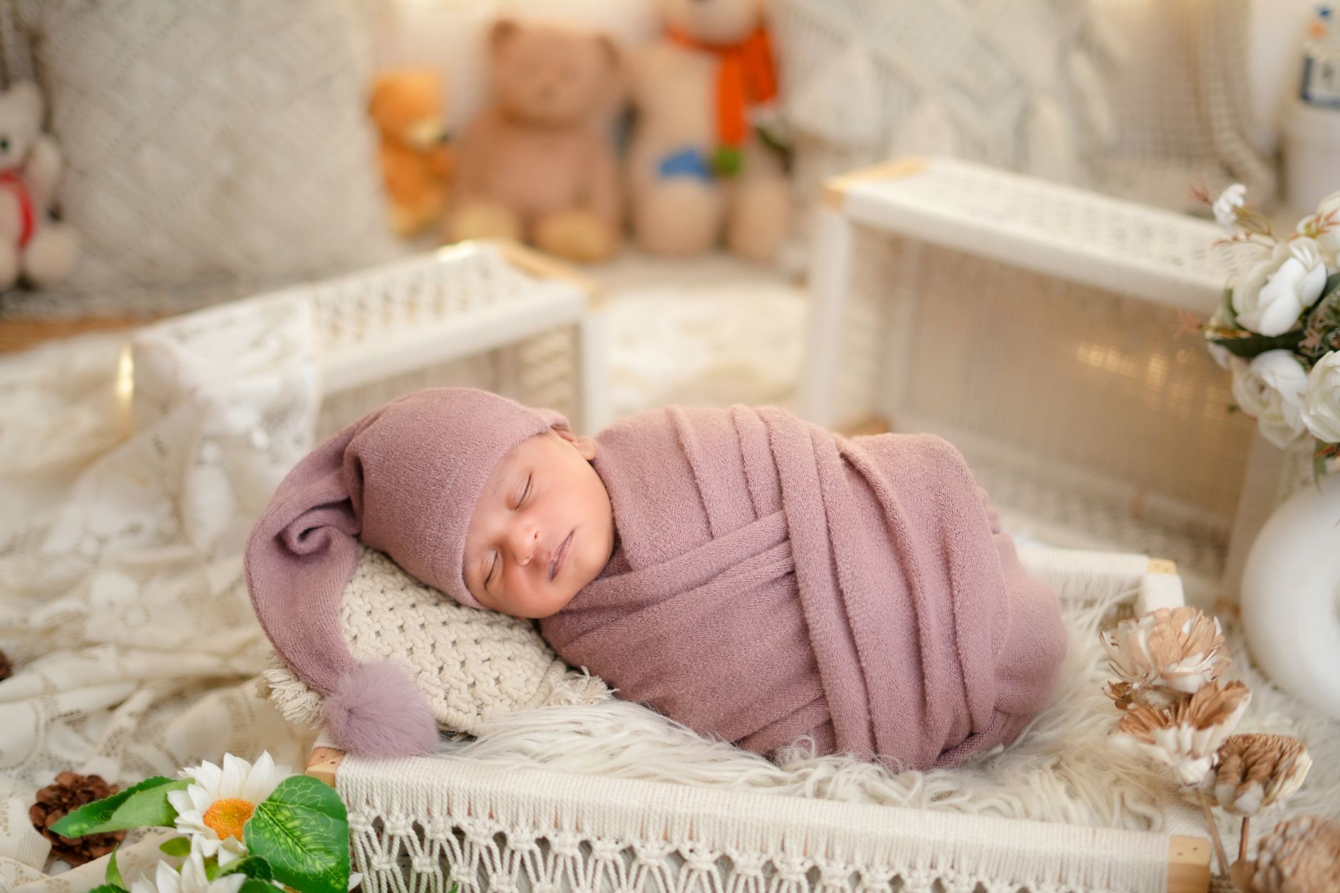 Pregnant woman holding a newborn, both smiling; the baby is wrapped in a soft blanket, emphasizing a healthy birth