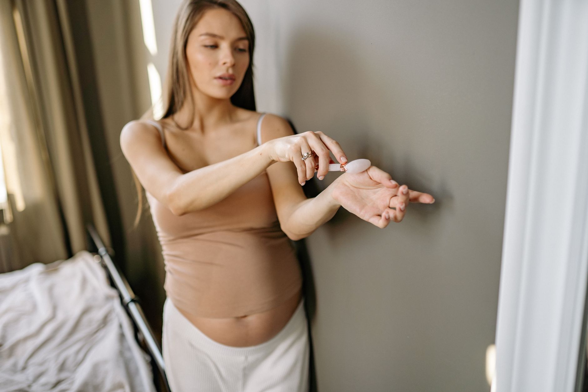 A calming scene of a pregnant woman holding a warm compress on her lower back, illustrating a non‑drug pain‑relief method.