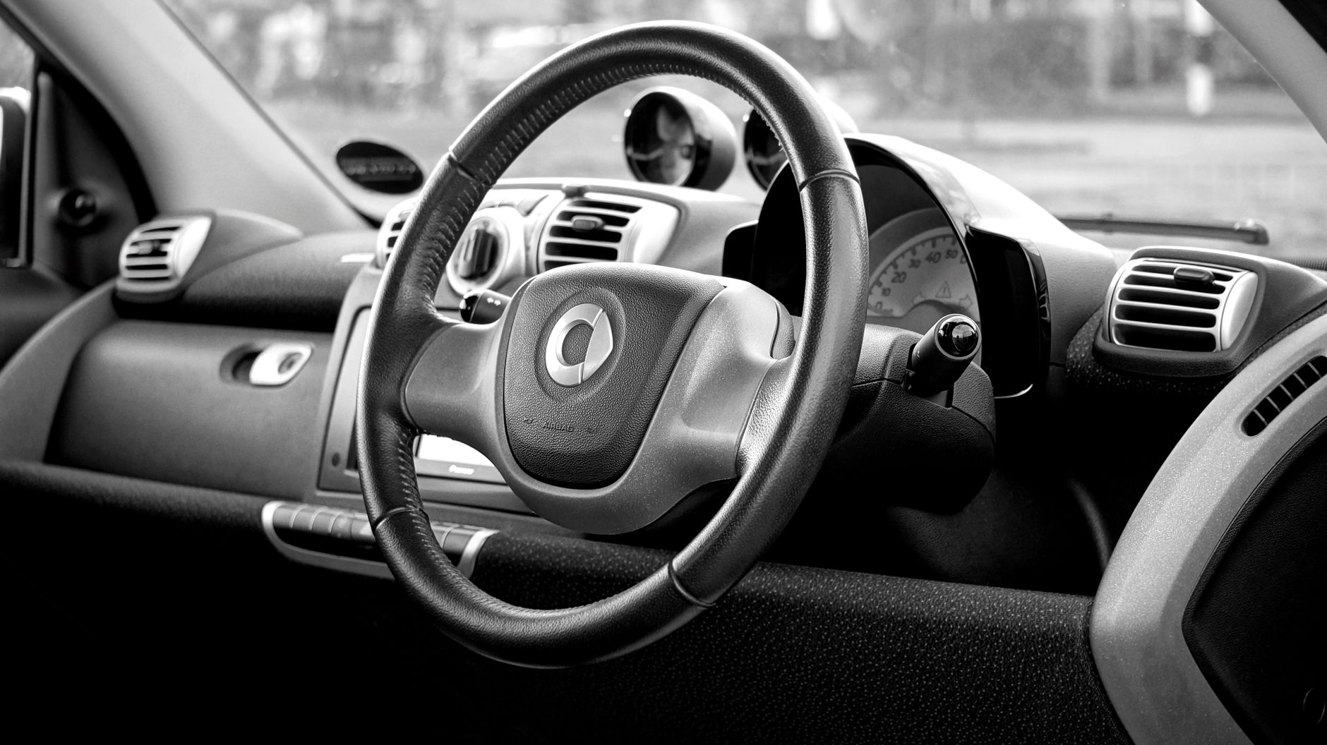 activated charcoal air purifier bag placed on a car dashboard to absorb new car smell and VOCs