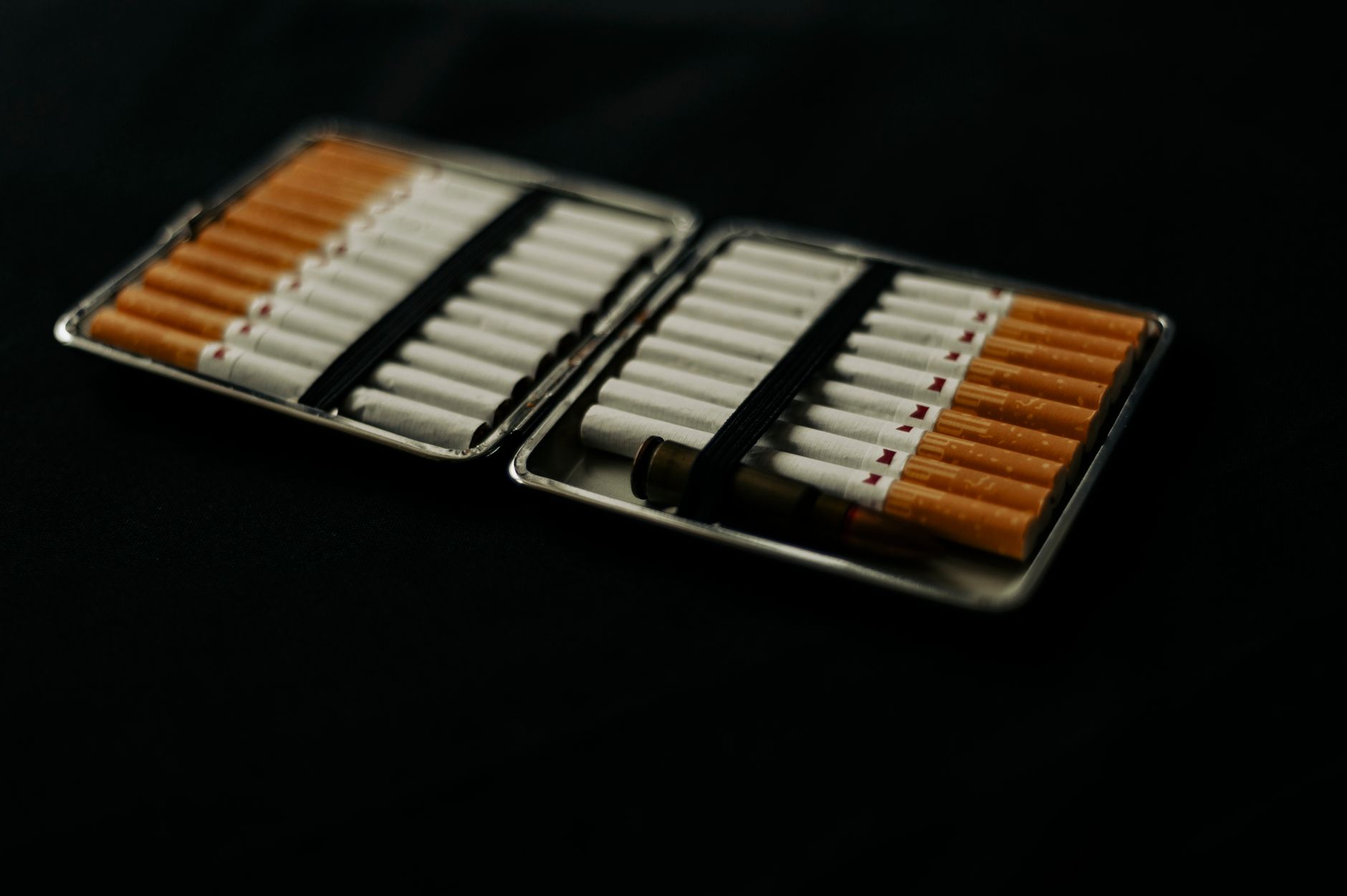 Various types of nicotine replacement therapy (NRT) products on a clean surface, including gum, patches, and lozenges, next to a pregnancy information booklet
