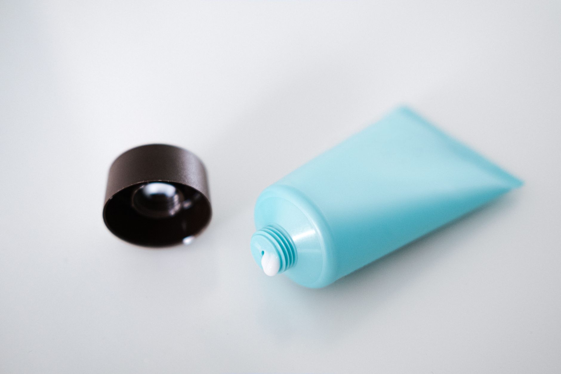 A close‑up of a nystatin vaginal cream tube next to a pregnancy handbook, bright natural light highlighting the product label for clarity