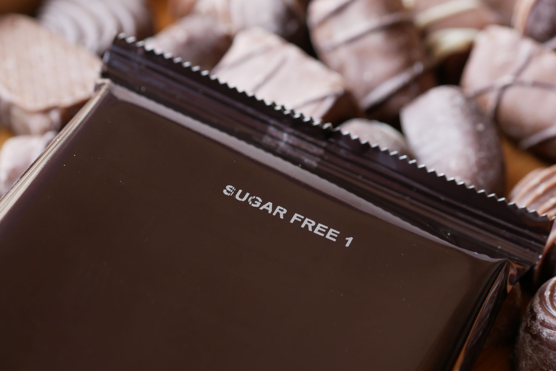 close‑up of a nutrition label on a peach ring candy package, highlighting sugar content and artificial color additives, soft indoor lighting