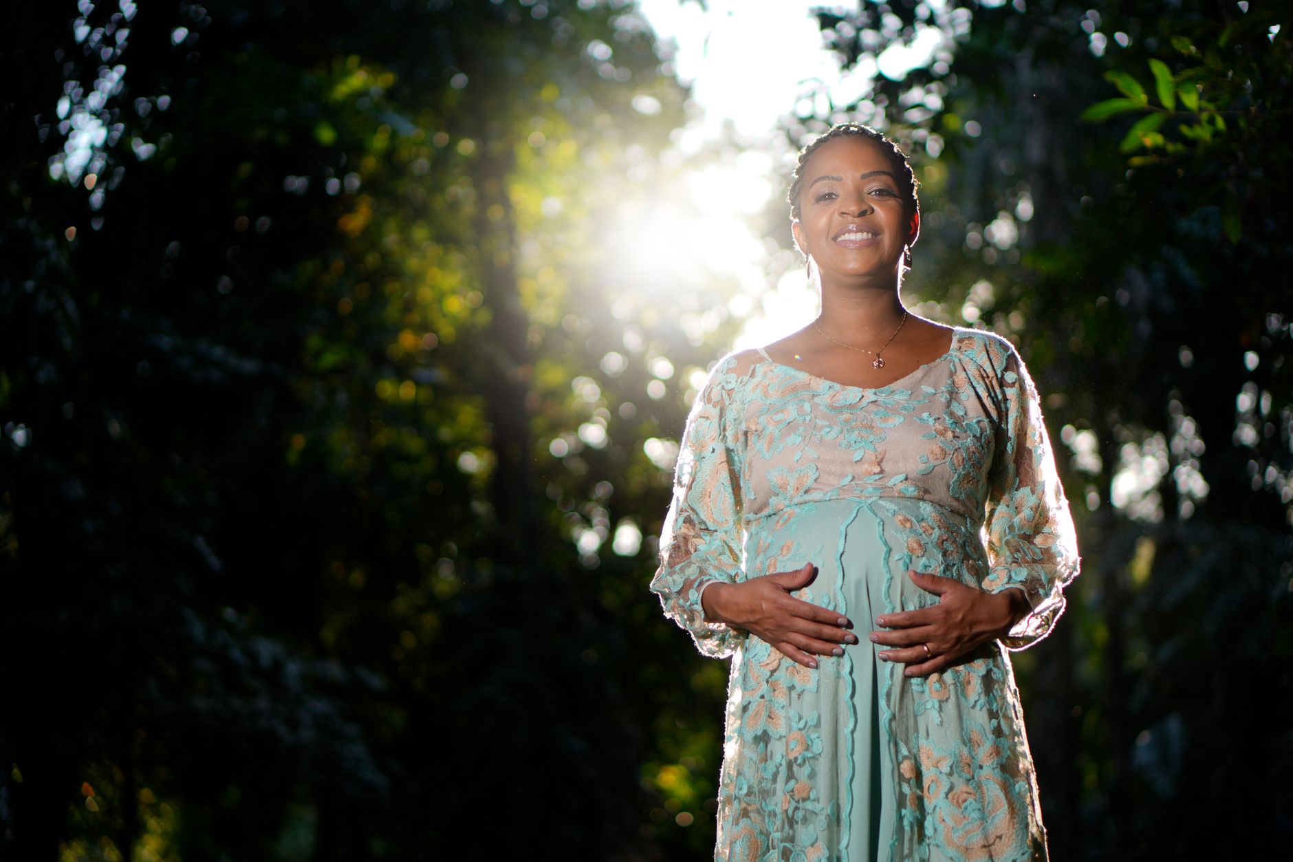 A pregnant woman walking in a park, wearing comfortable shoes and a supportive belly band, illustrating a safe, low‑impact activity for weight management during pregnancy.