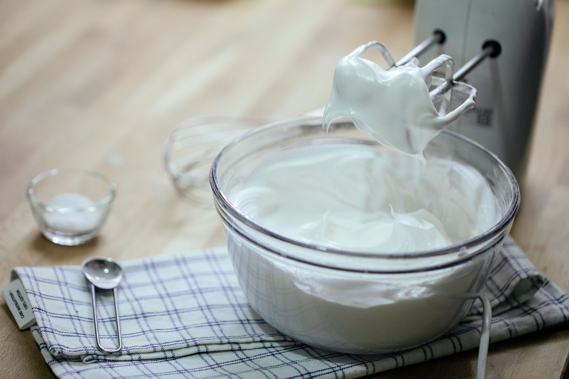 A selection of safer dairy alternatives for pregnant people, including cottage cheese, Greek yogurt, cream cheese, and avocado spread, arranged on a pastel kitchen countertop
