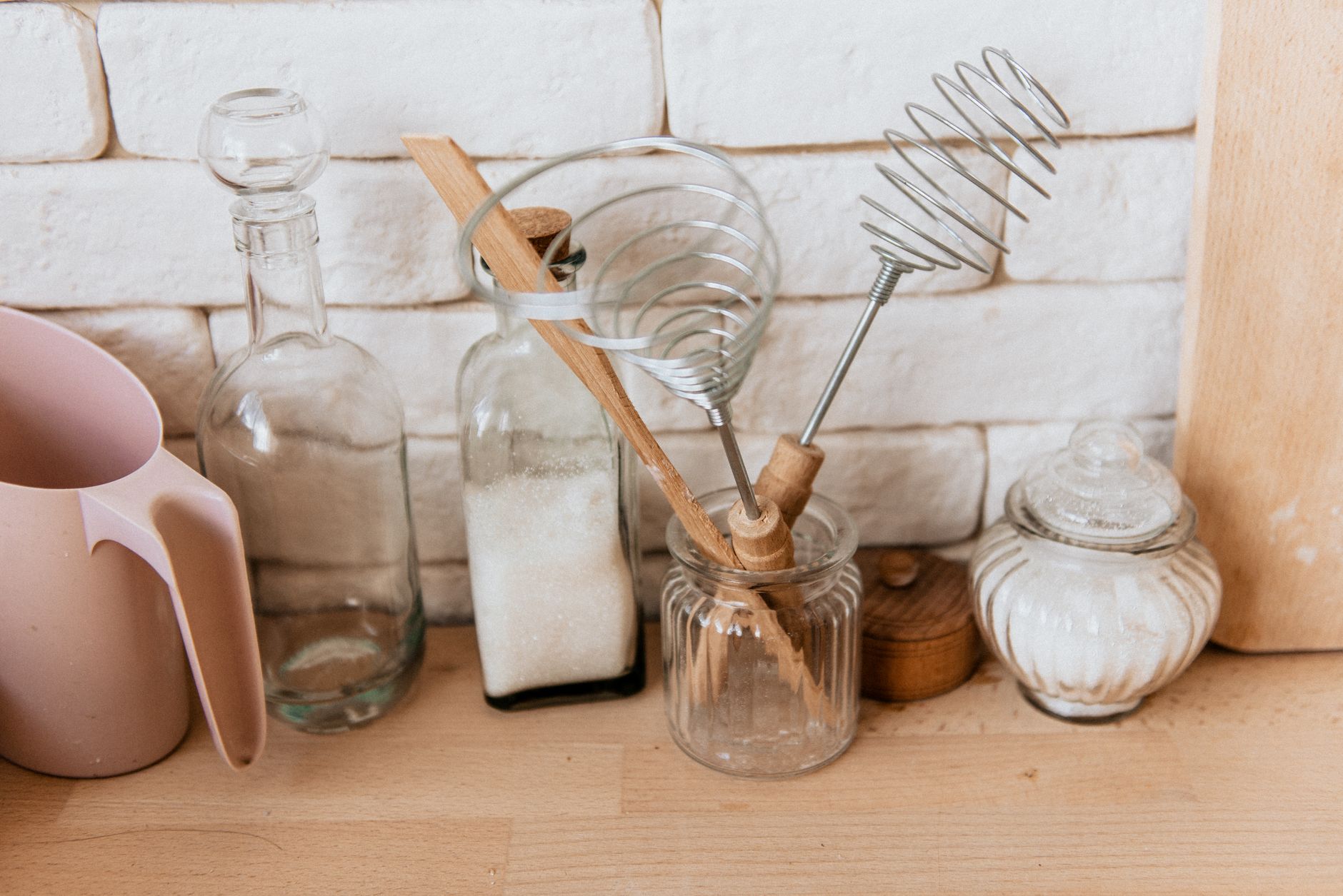 A collection of pregnancy‑safe roach‑control tools, including diatomaceous earth, sticky traps, and a peppermint‑oil spray bottle, arranged on a kitchen countertop