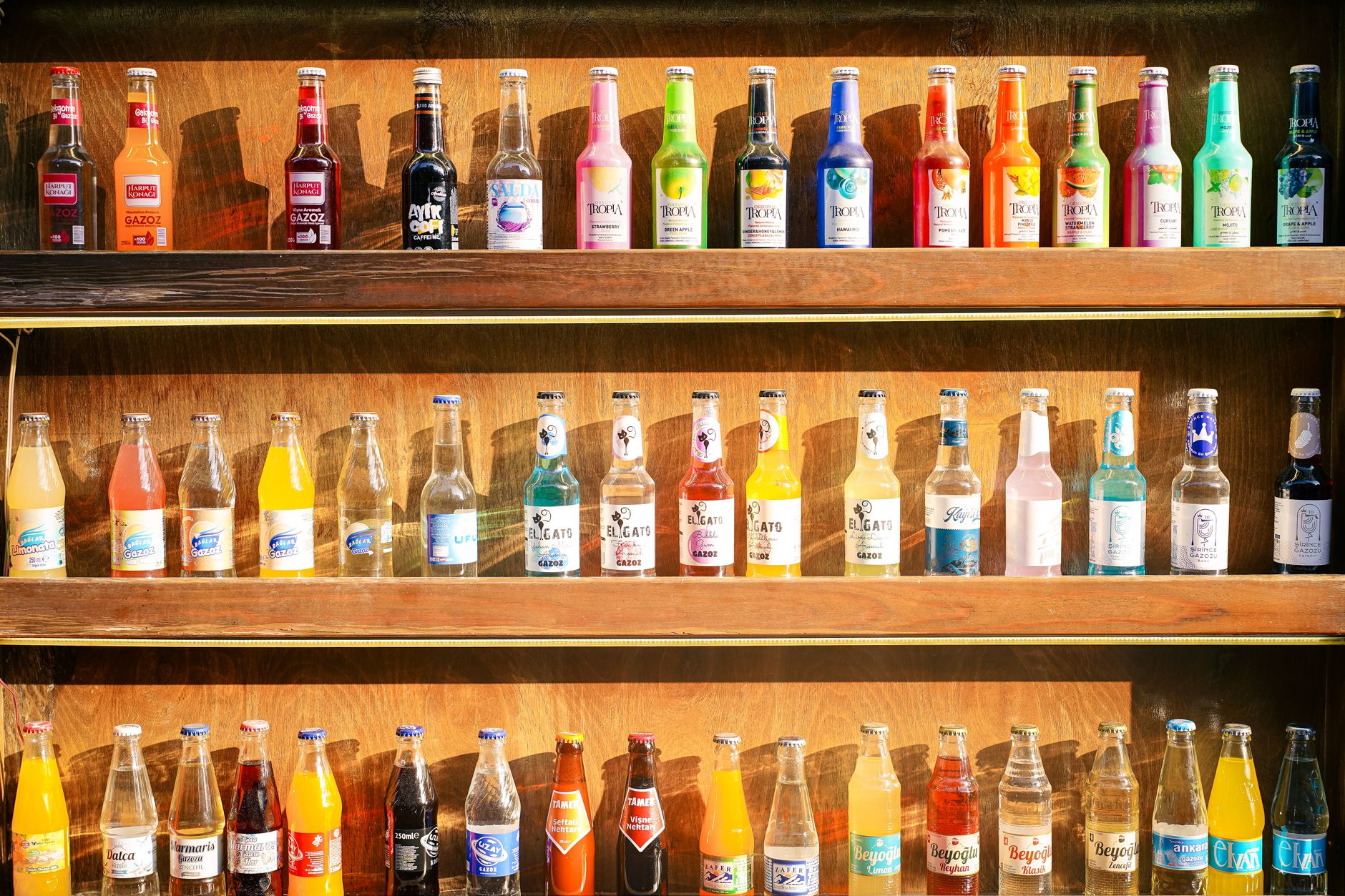 A selection of non‑alcoholic Japanese beverages, including pear juice, green tea, Calpis, and yuzu soda, arranged on a bright kitchen counter