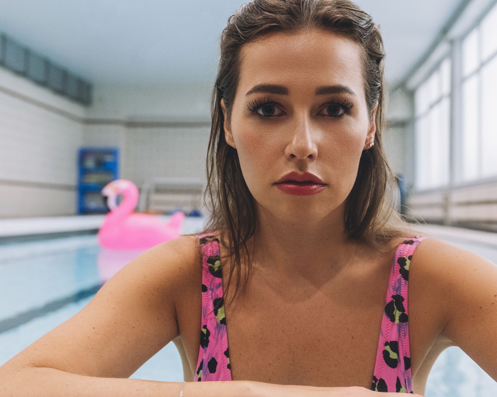 a pregnant woman floating peacefully in a shallow pool, surrounded by floating toys and a gentle water ripple, illustrating a safe water alternative