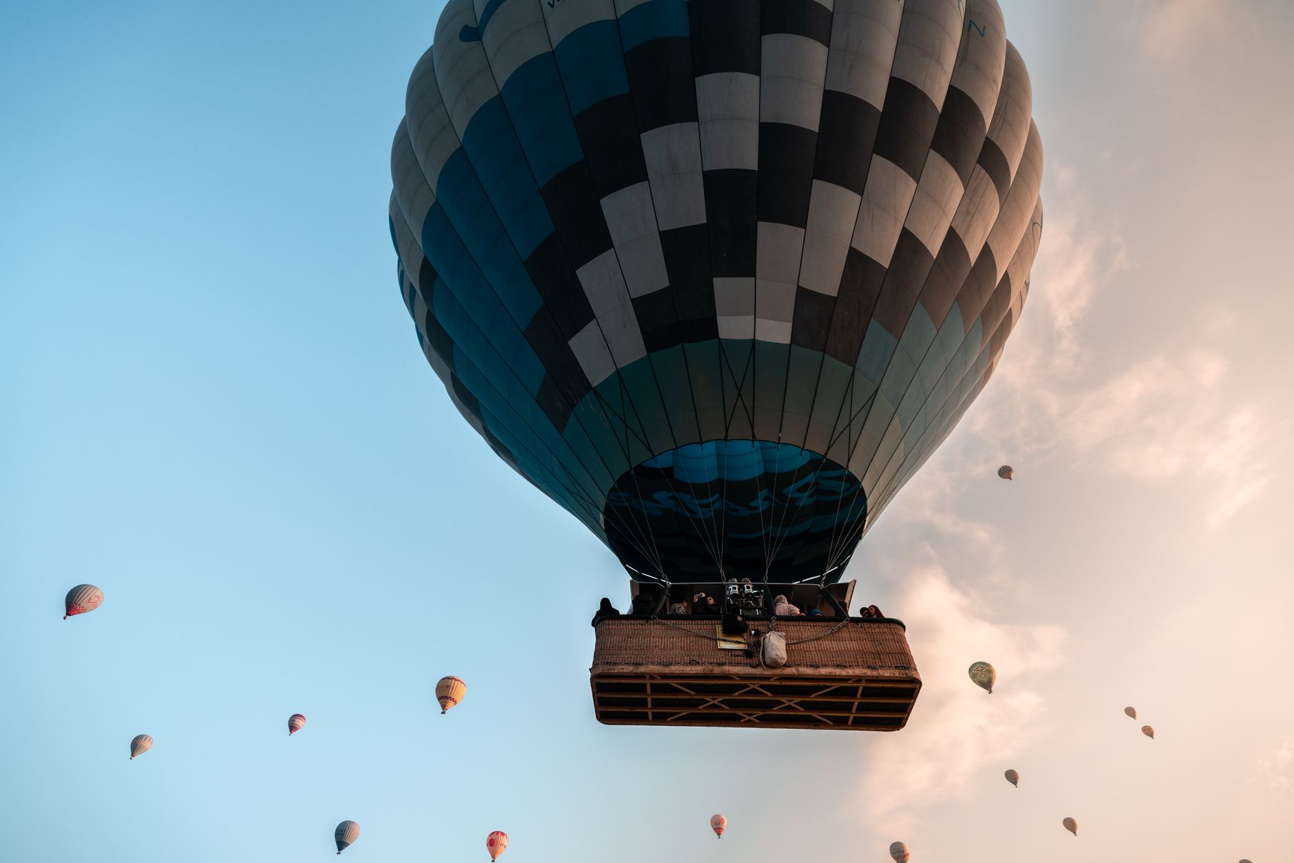 a hot air balloon floating gently over a sunrise landscape, showing a serene alternative activity for expectant mothers seeking adventure without high‑impact stress