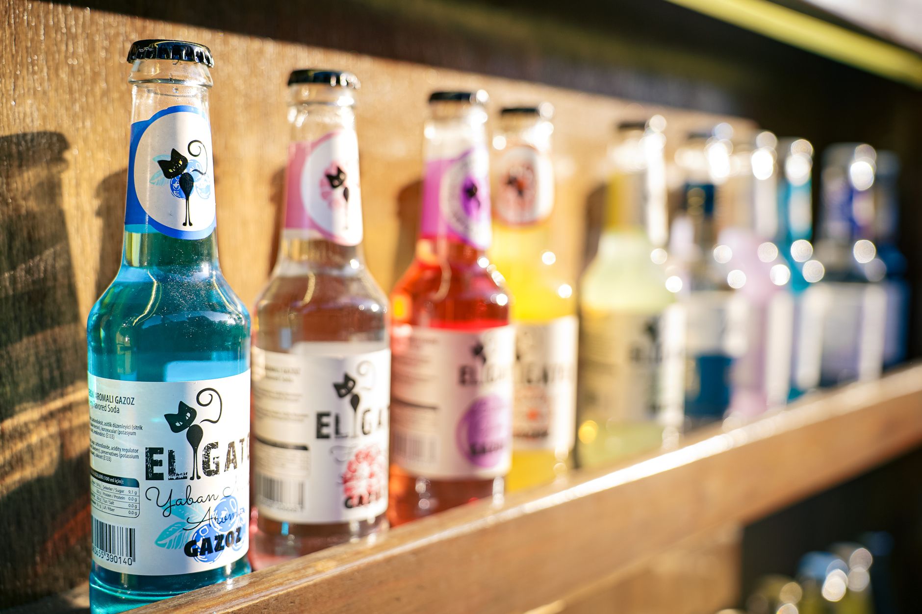A selection of pregnancy‑friendly sparkling water bottles on a pantry shelf, each labeled with low‑sugar, no‑caffeine, and low‑sodium claims.