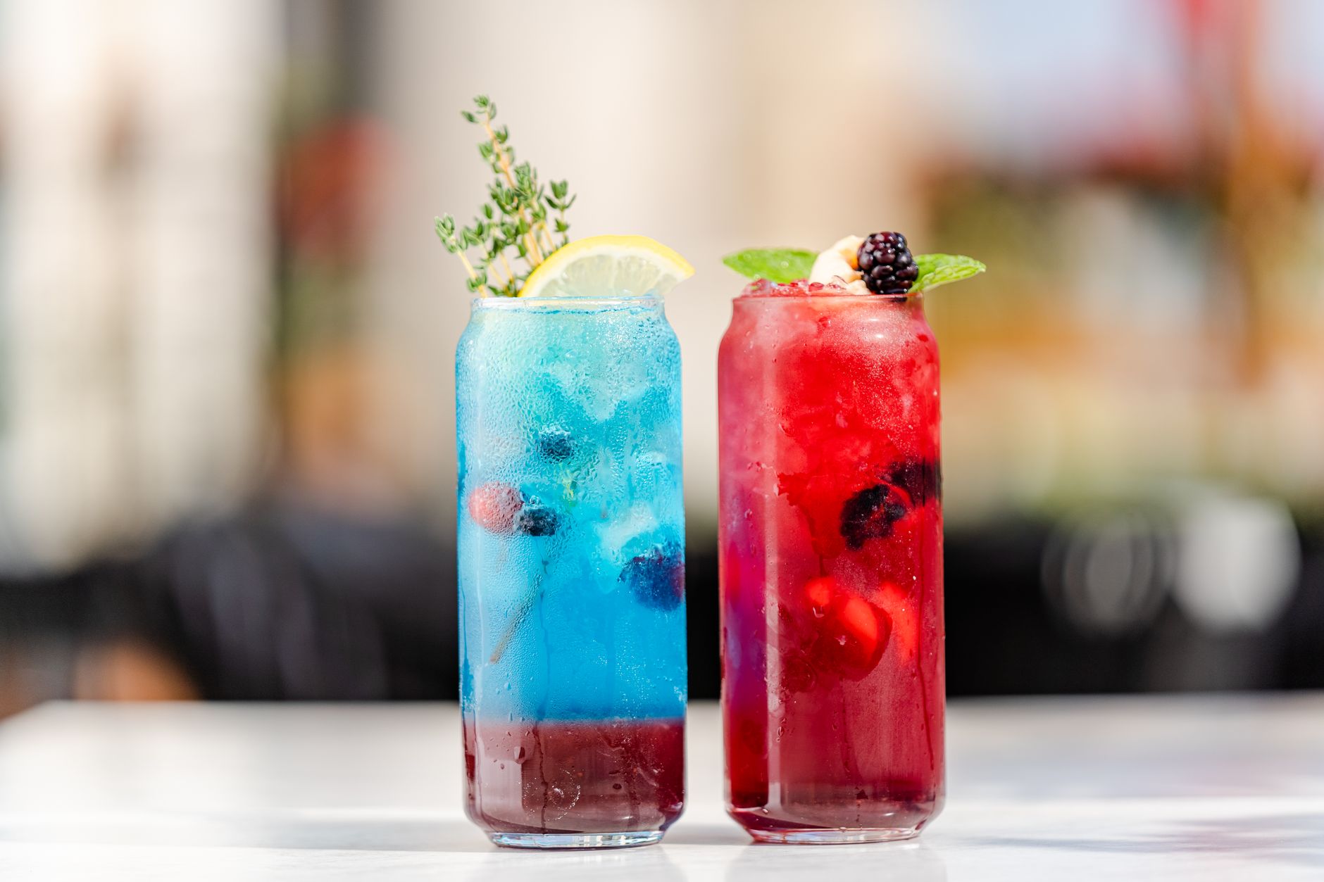 a festive mocktail made with sparkling water, fresh berries, and mint leaves in a clear glass, bright natural light, elegant composition