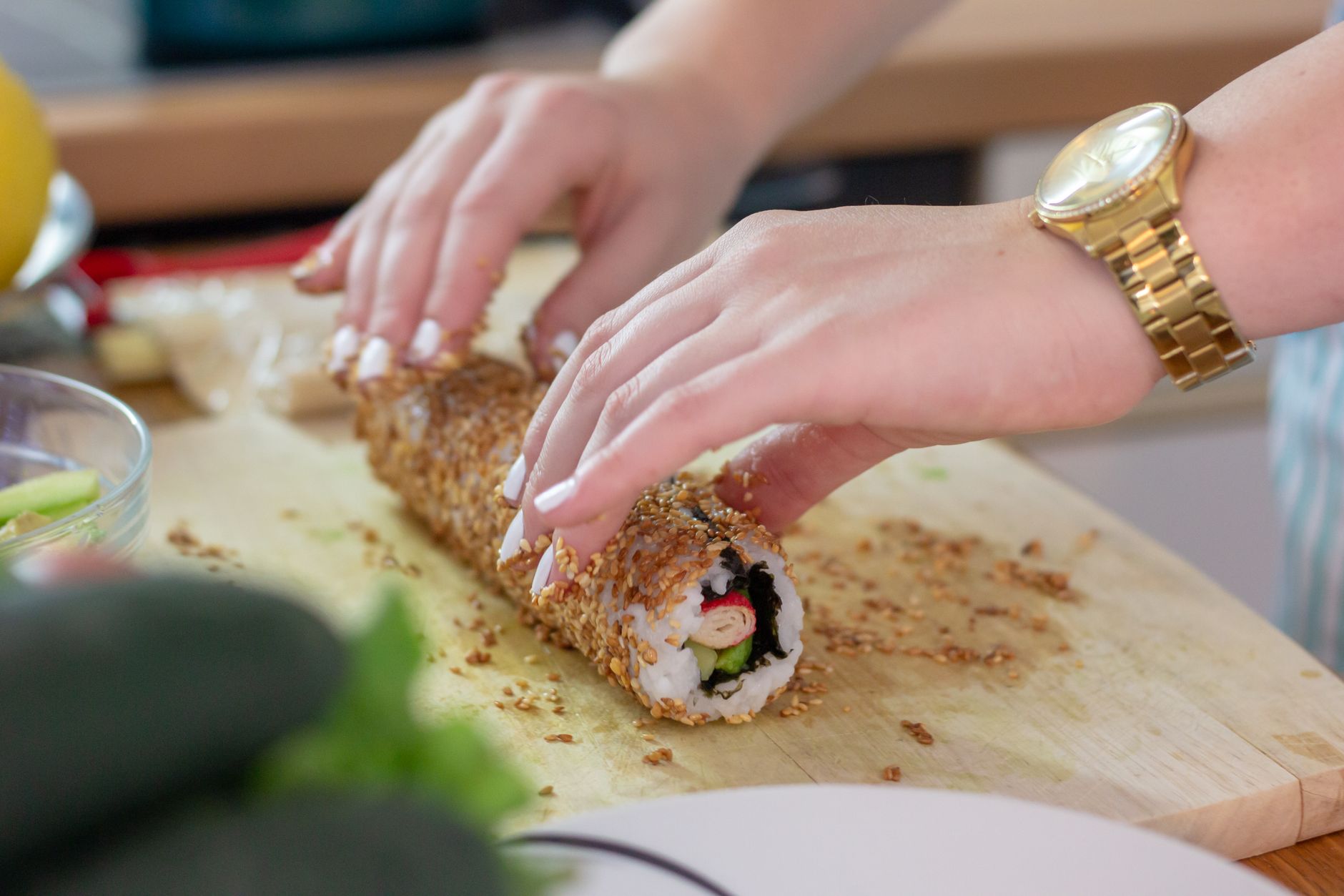 a smiling pregnant woman holding a plate of avocado roll and cucumber roll, illustrating safe sushi choices during pregnancy