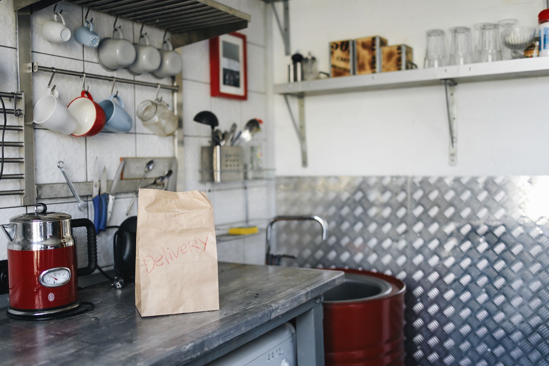 A tidy kitchen counter with a teapot, a digital scale, and a pack of certified organic tea bags, illustrating careful measurement and preparation for a pregnancy‑safe brew