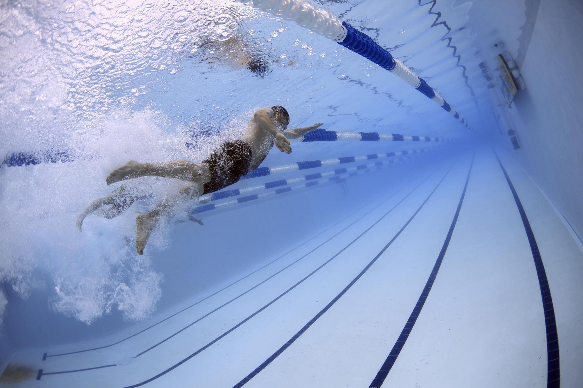 a serene indoor pool with a pregnant woman doing gentle water exercises, sunlight filtering through tall windows, emphasizing low‑impact prenatal fitness